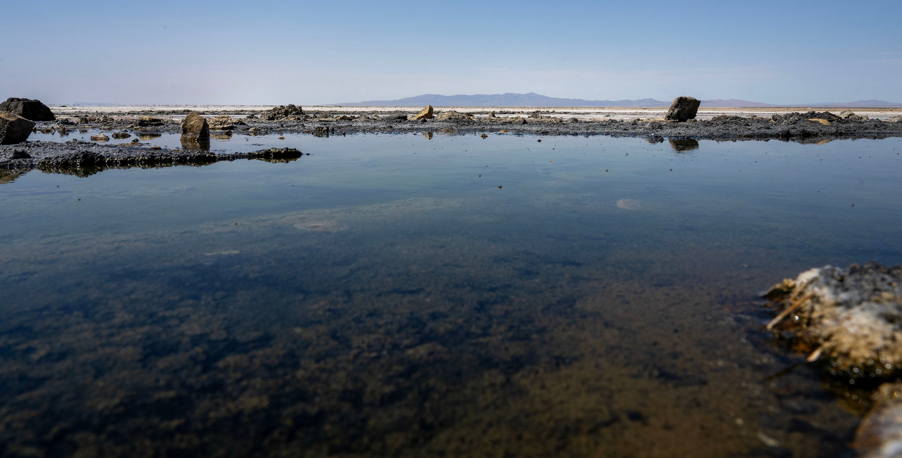 Water reflects the sky near Lone Rock on what used to be a beach area on the Great Salt Lake. Media members and other interested parties took a tour of the Hansel Valley and surrounding areas near the proposed data center in Box Elder County on July 13.