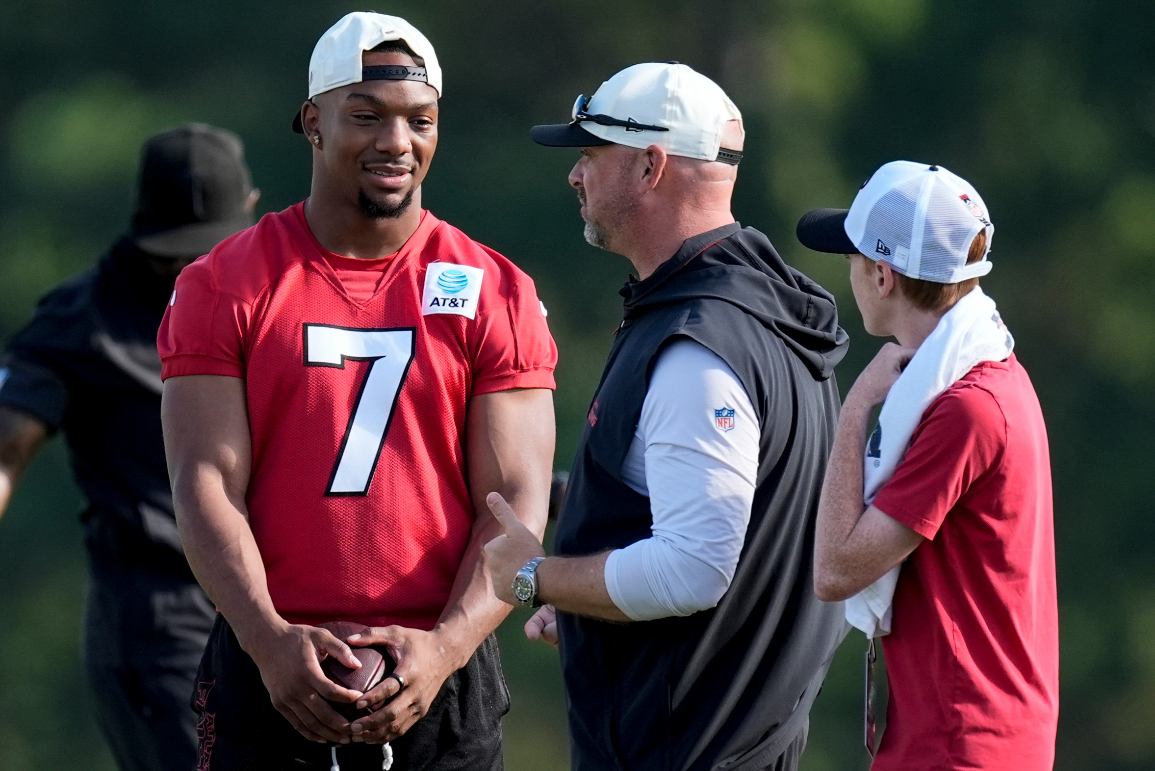 Atlanta Falcons running back Bijan Robinson (7) speak to a coach during a Atlanta Falcons training camp, Monday, Aug. 3, 2026, in Flowery Branch, Ga. 