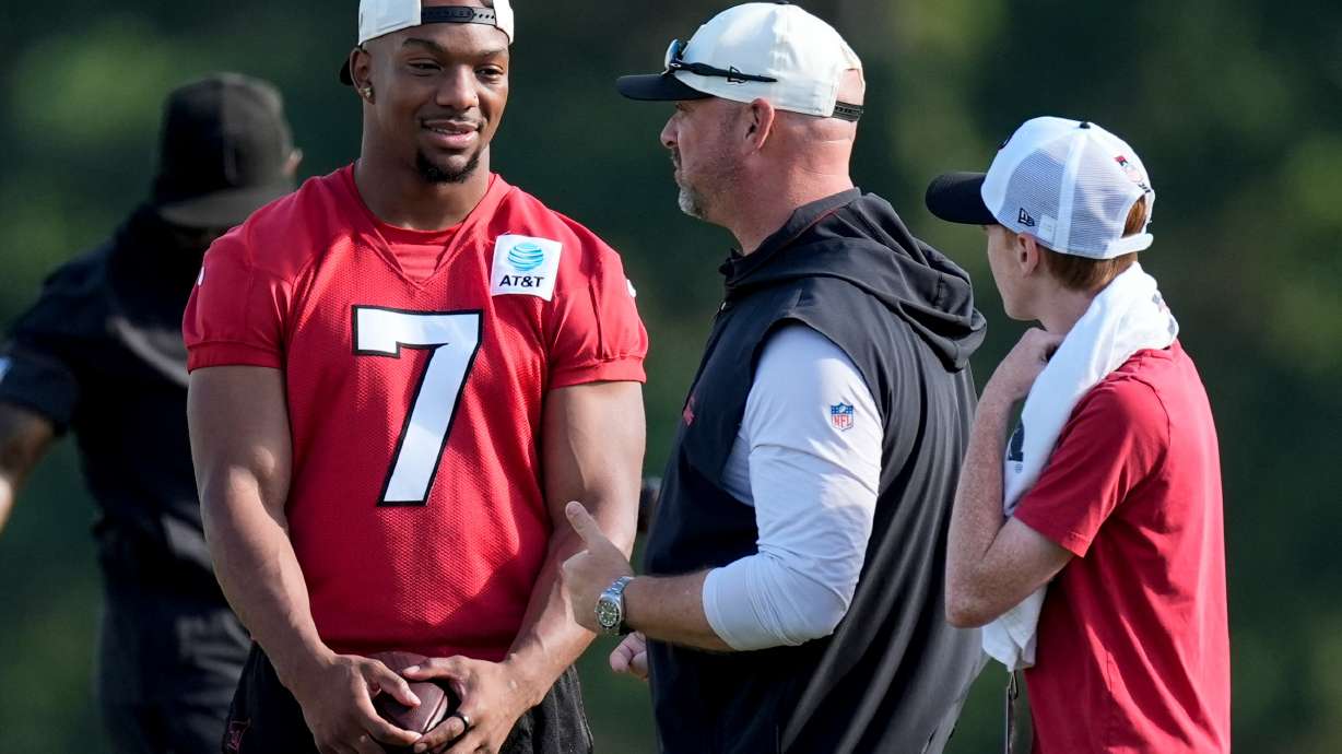 Atlanta Falcons running back Bijan Robinson (7) speak to a coach during a Atlanta Falcons training camp, Monday, Aug. 3, 2026, in Flowery Branch, Ga.