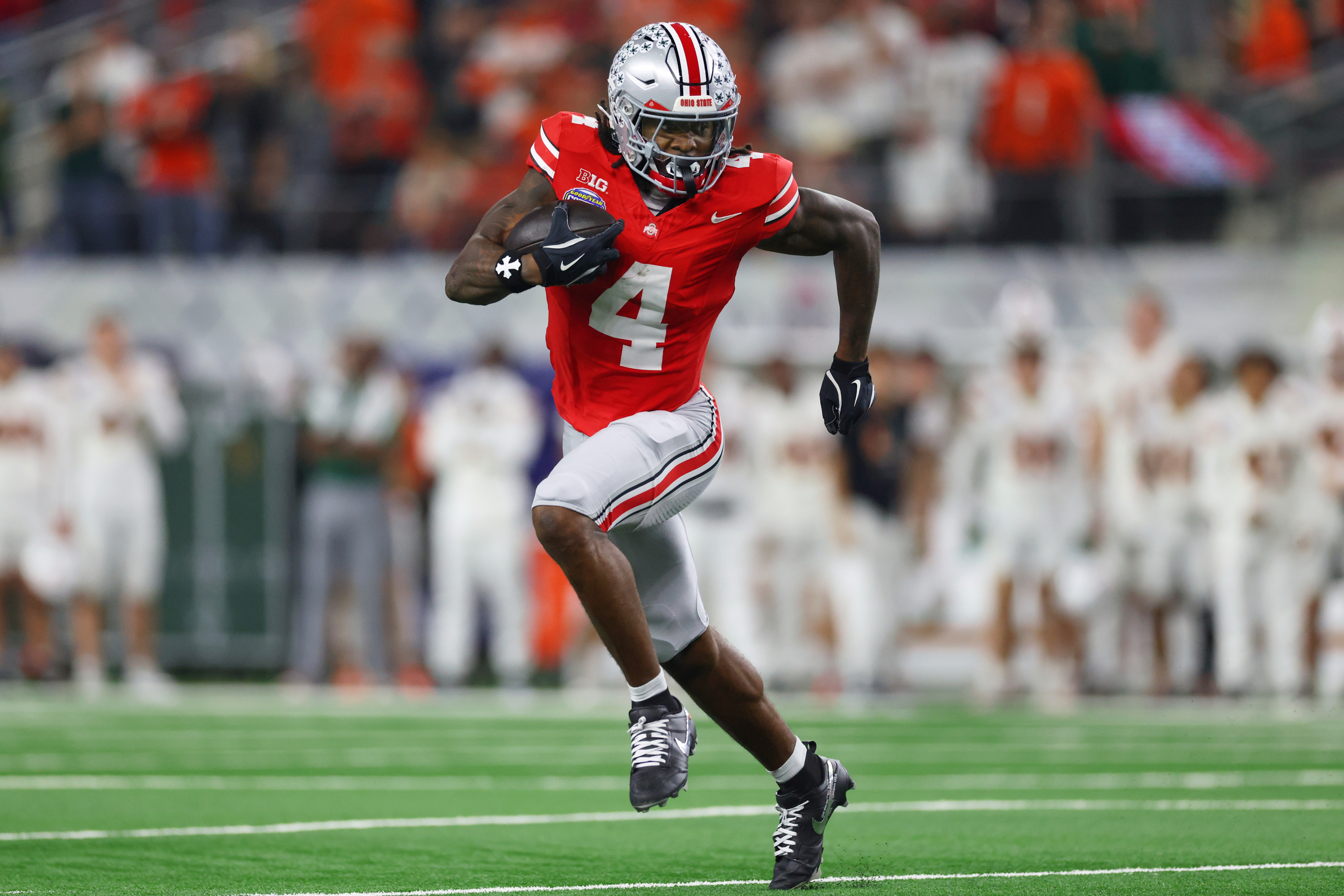 FILE - Ohio State wide receiver Jeremiah Smith runs the ball against Miami during the second half of the Cotton Bowl College Football Playoff quarterfinal game, Dec. 31, 2025, in Arlington, Texas. 