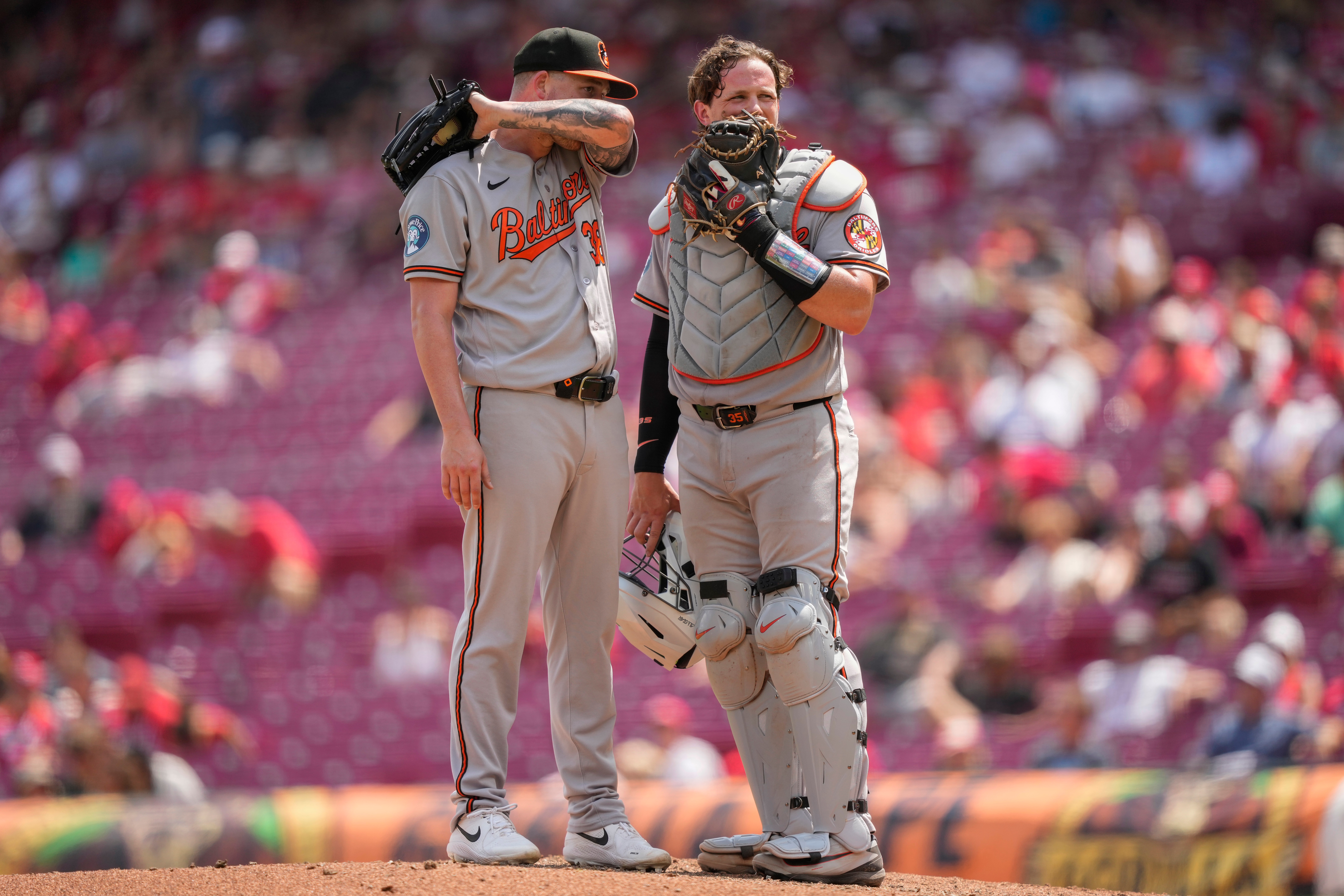 Baltimore Orioles pitcher Kyle Bradish, left, and catcher Adley Rutschman, right, talk on the mound during the eighth inning of a baseball game against the Cincinnati Reds in Cincinnati, Sunday, July 5, 2026. 