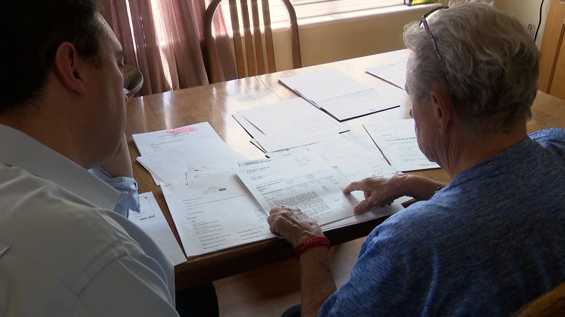 Marilyn Newbold shows KSL's Matt Gephardt the documentation that she paid for three months of service after AT&T threatened to send her to collections.