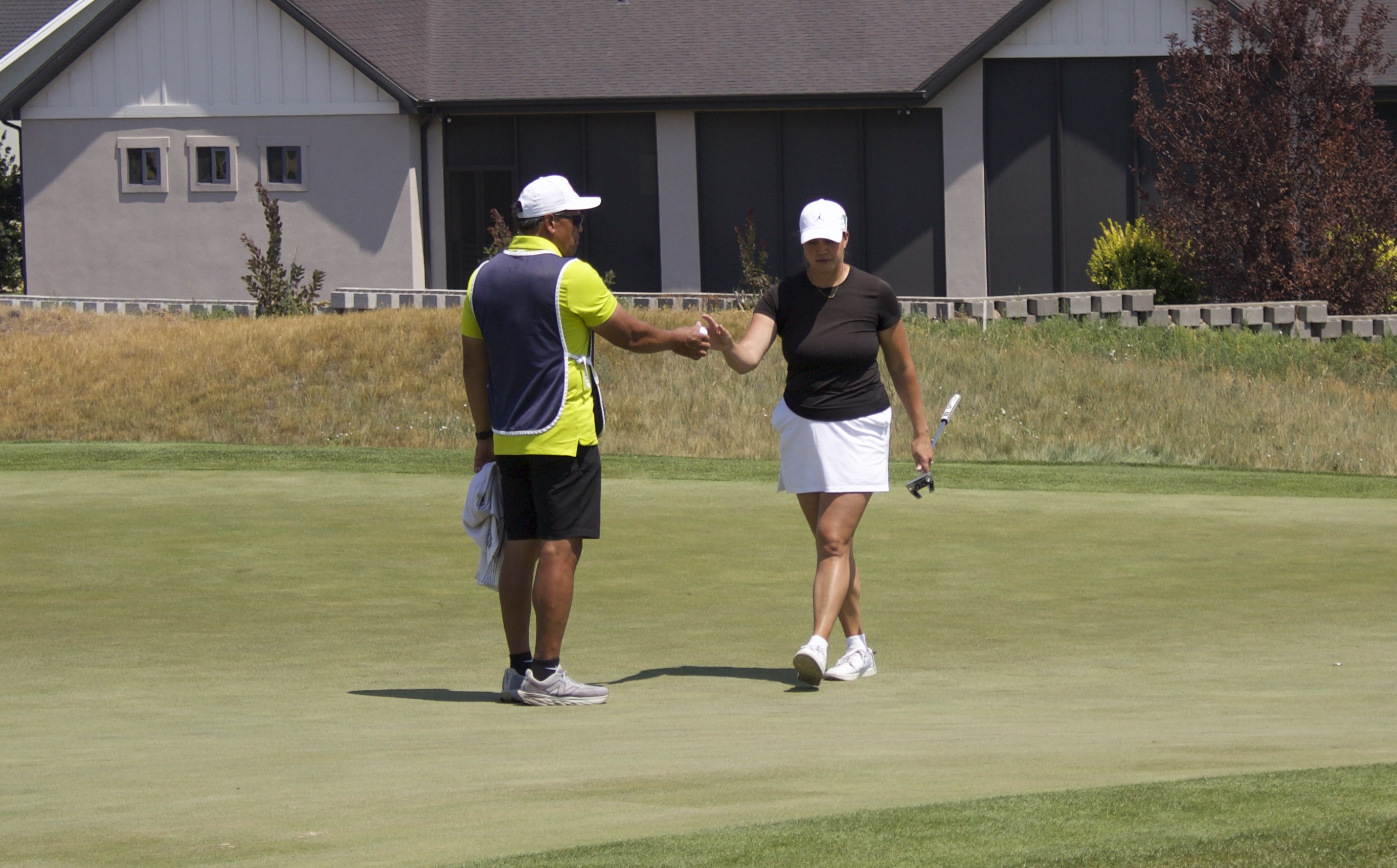 Former BYU golfer Kerstin Ngakuru hands off her ball during the final round of the 10th annual Larry H. Miller Utah Women's Open, Tuesday, Aug. 4, 2026 at TalonsCove Golf Course in Saratoga Springs.