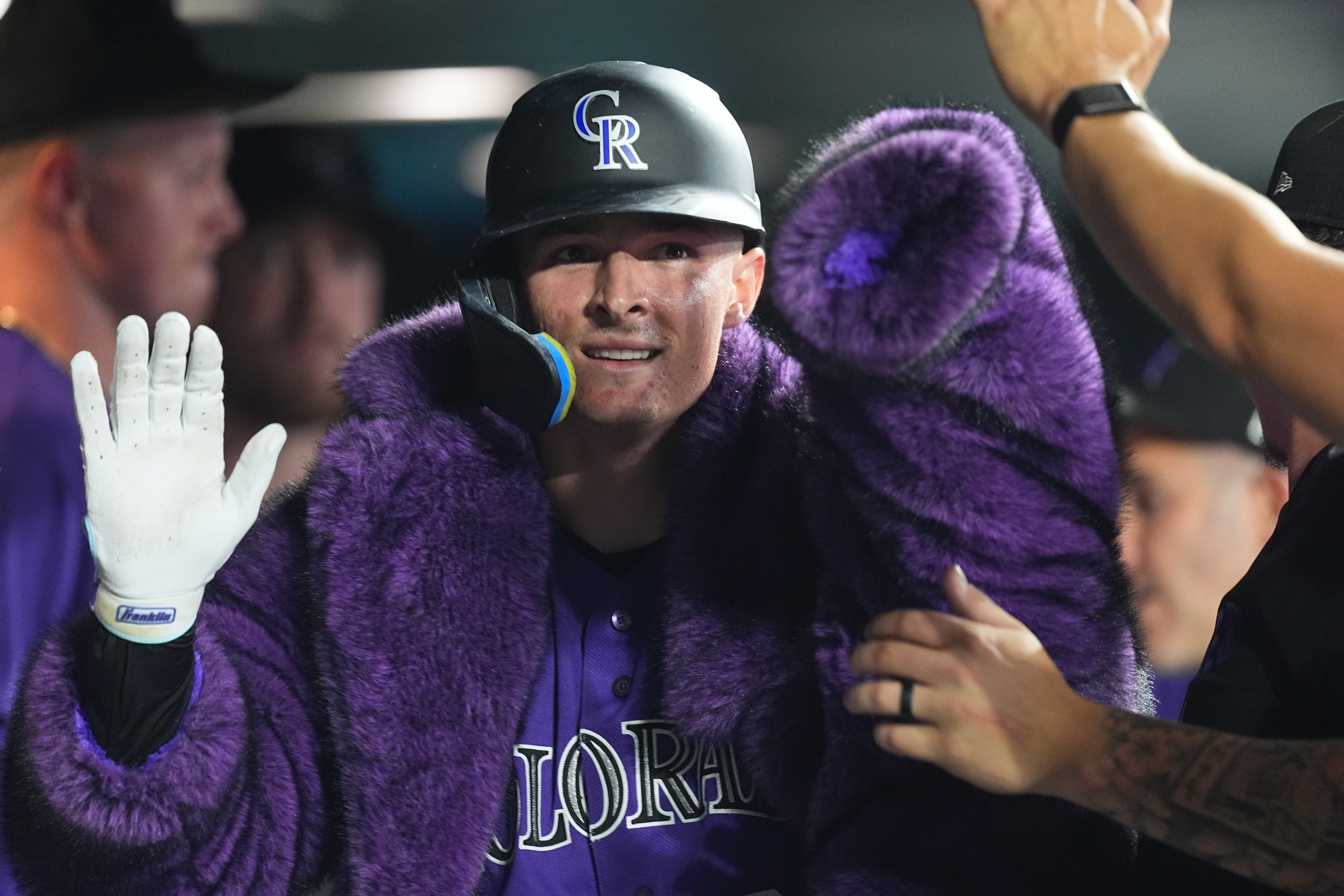 Colorado Rockies' Mickey Moniak is congratulated as he returns to the dugout after hitting a solo home run off Tampa Bay Rays relief pitcher Michael Grove in the eighth inning of a baseball game Monday, Aug. 3, 2026, in Denver. 