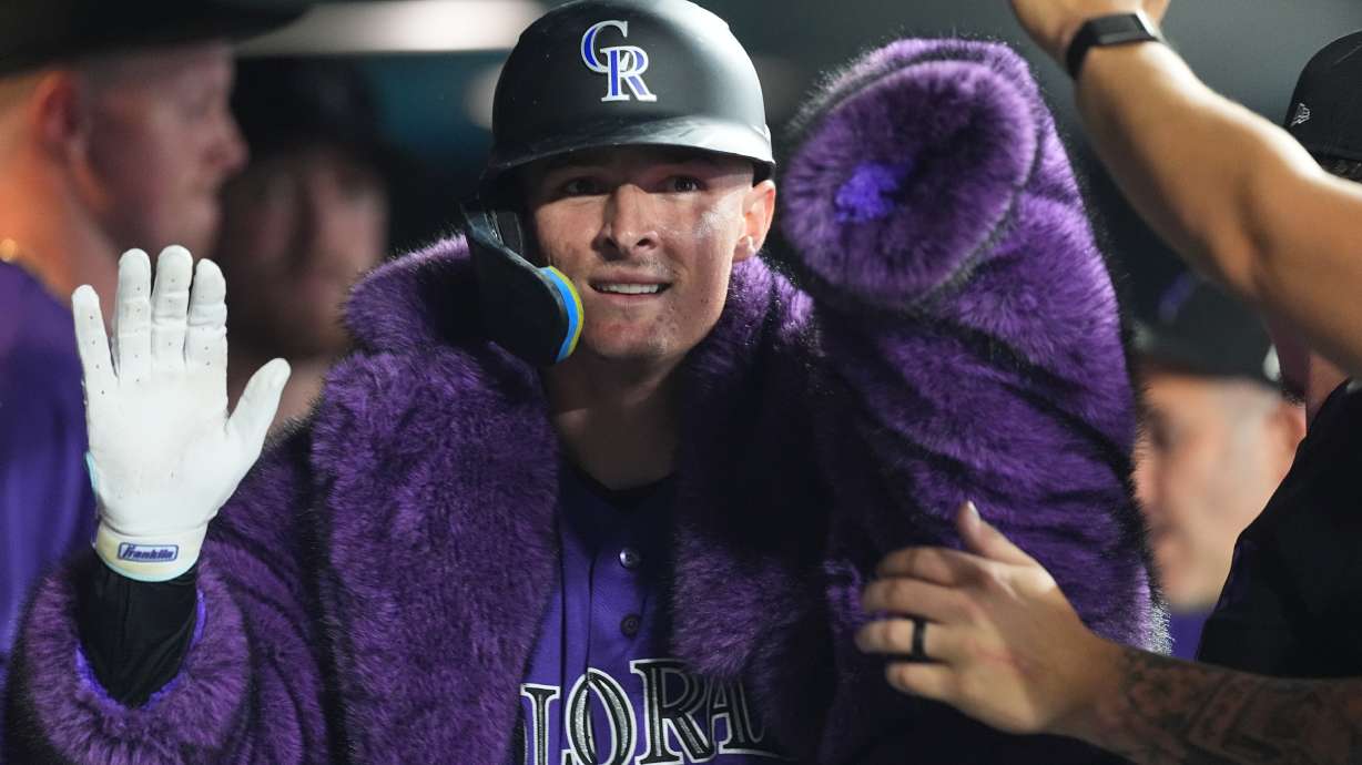 Colorado Rockies' Mickey Moniak is congratulated as he returns to the dugout after hitting a solo home run off Tampa Bay Rays relief pitcher Michael Grove in the eighth inning of a baseball game Monday, Aug. 3, 2026, in Denver.