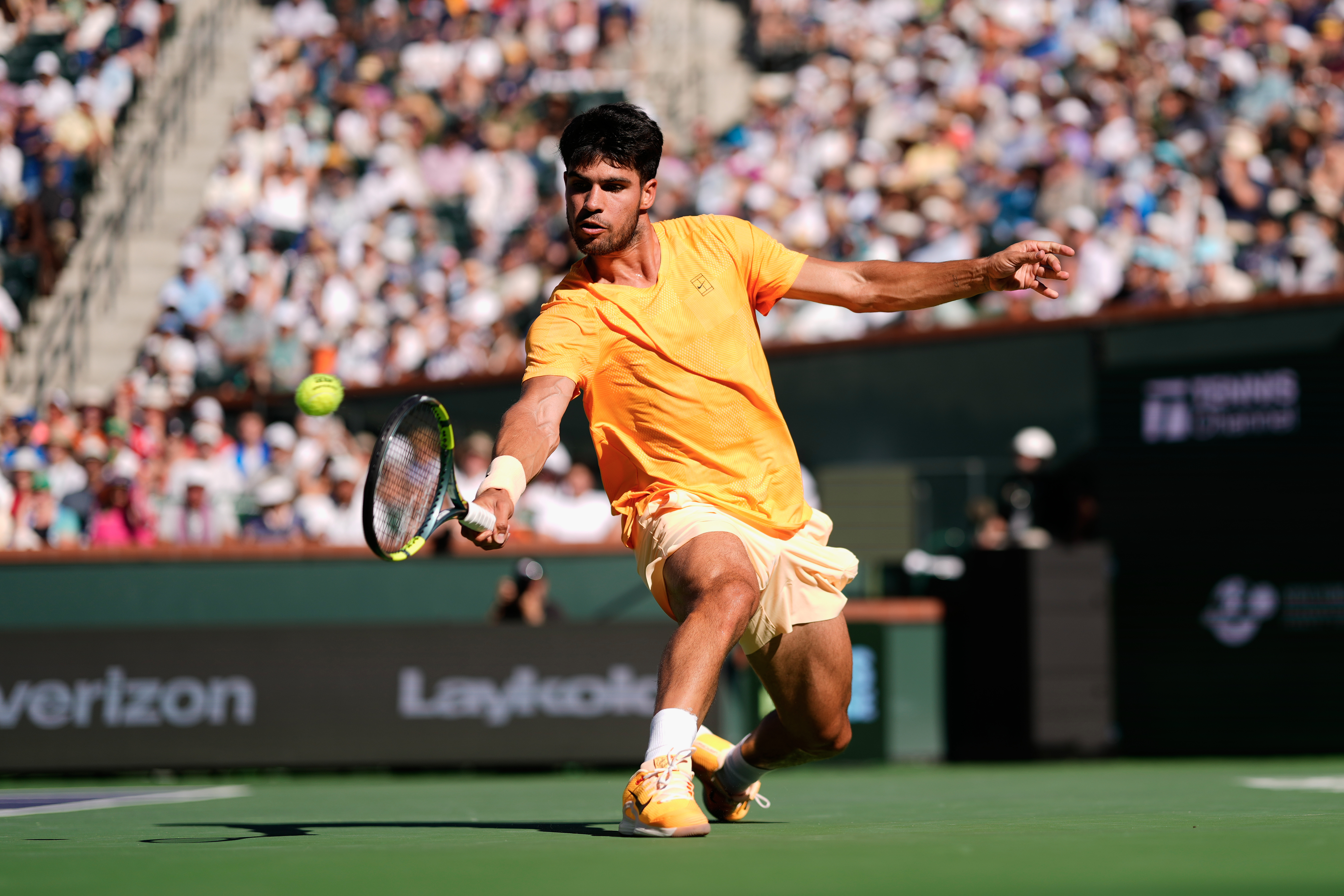 FILE - Carlos Alcaraz, of Spain, returns a shot against Daniil Medvedev, of Russia, during a semifinal match at the BNP Paribas Open tennis tournament, March 14, 2026, in Indian Wells, Calif. 