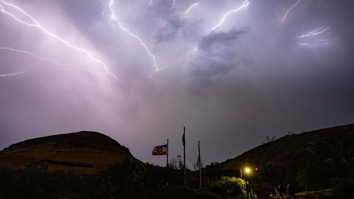 Lightning flashes above Ensign Peak during a thunderstorm in Salt Lake City on July 21. Storms last month helped elevate soil moisture levels statewide, but federal hydrologists say some regions benefitted more than others.