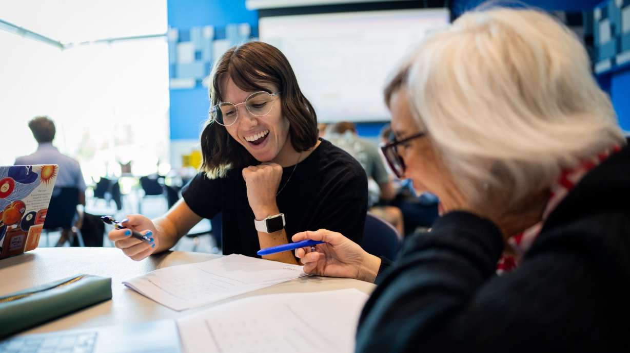 New teachers Sydney Little, English teacher at Hillcrest High School, and Stephanie Yorgason, math teacher at Alta High School, participate in new teacher training at Union Middle School in Sandy on Tuesday.