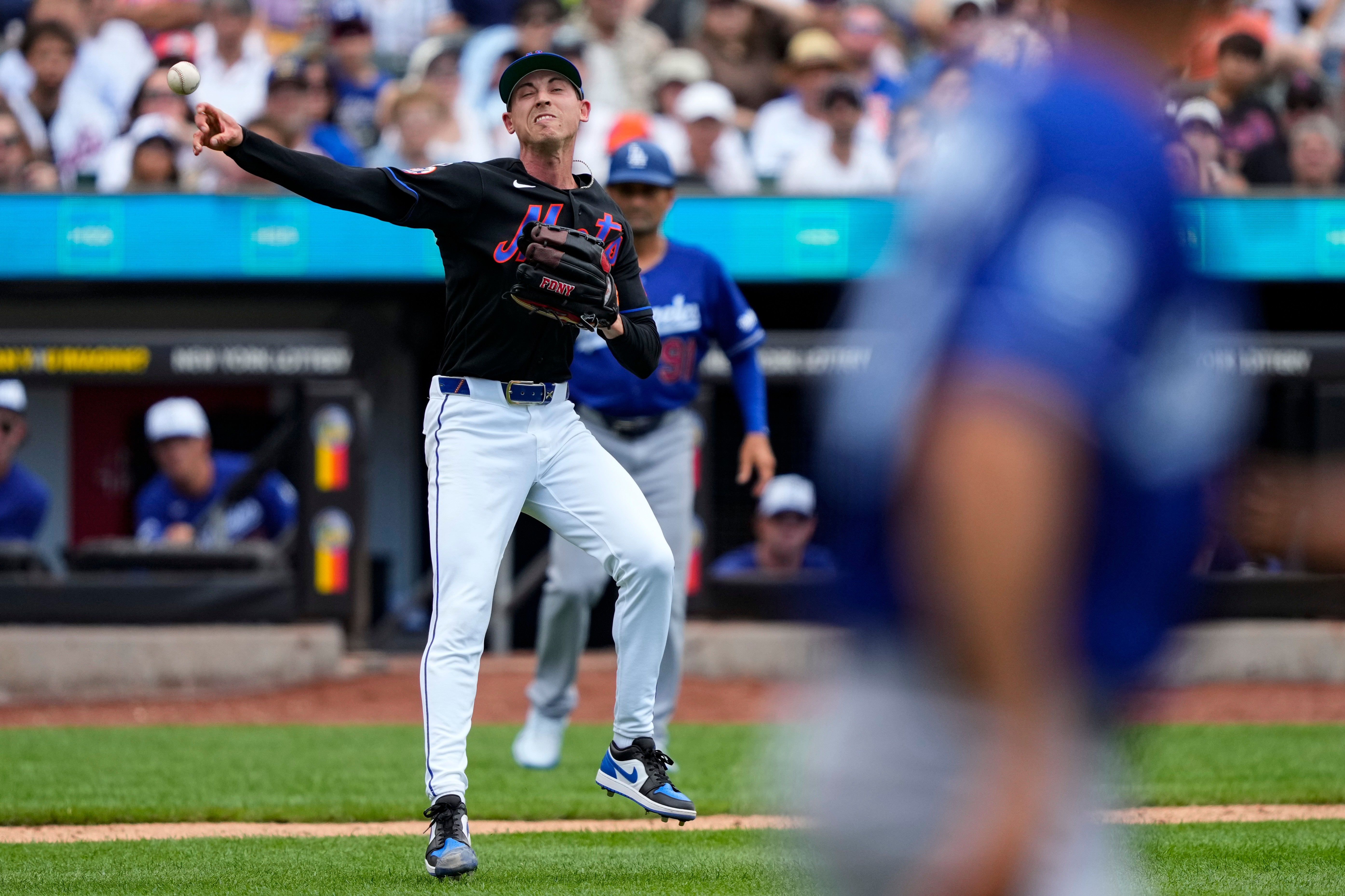 New York Mets pitcher Luke Weaver throws out Los Angeles Dodgers' Teoscar Hernández at first base during the eighth inning of a baseball game, Sunday, July 26, 2026, in New York. 