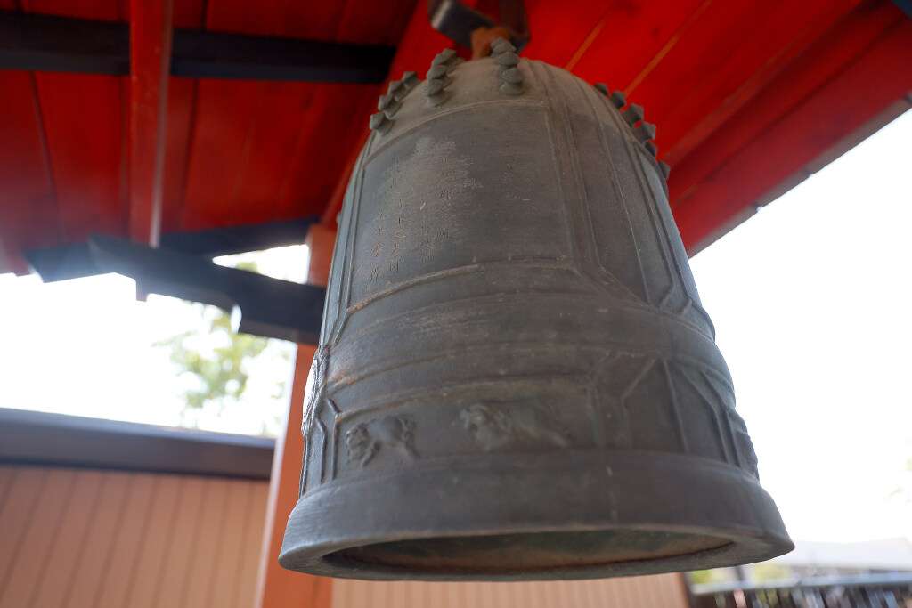 A bell donated by the Mitsunaga family, with family members’ names inscribed on it, hangs outside the Salt Lake Buddhist Temple in Salt Lake City on Aug. 4. The bell is rung 108 times before every service.