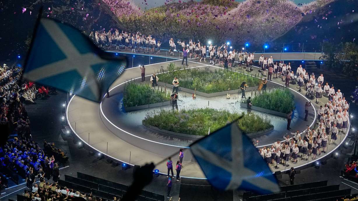 Scottish flags are waved by fans as the Scotland team arrives on stage during the Commonwealth Games opening ceremony in Glasgow, Scotland, Thursday, July 23, 2026.