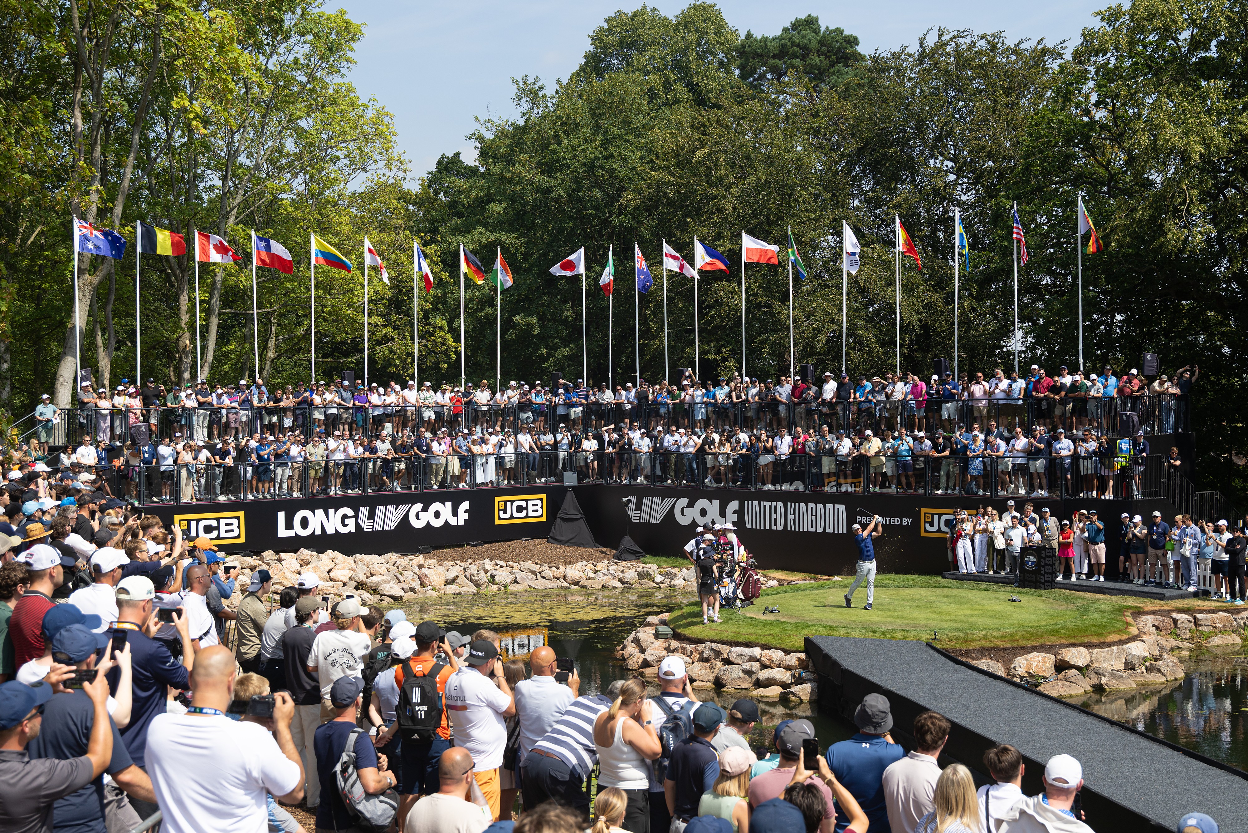 Captain Bryson DeChambeau, center right, of Crushers GC hits from the first tee during the second round of LIV Golf United Kingdom, Friday, July 24, 2026, in Rocester, England. 