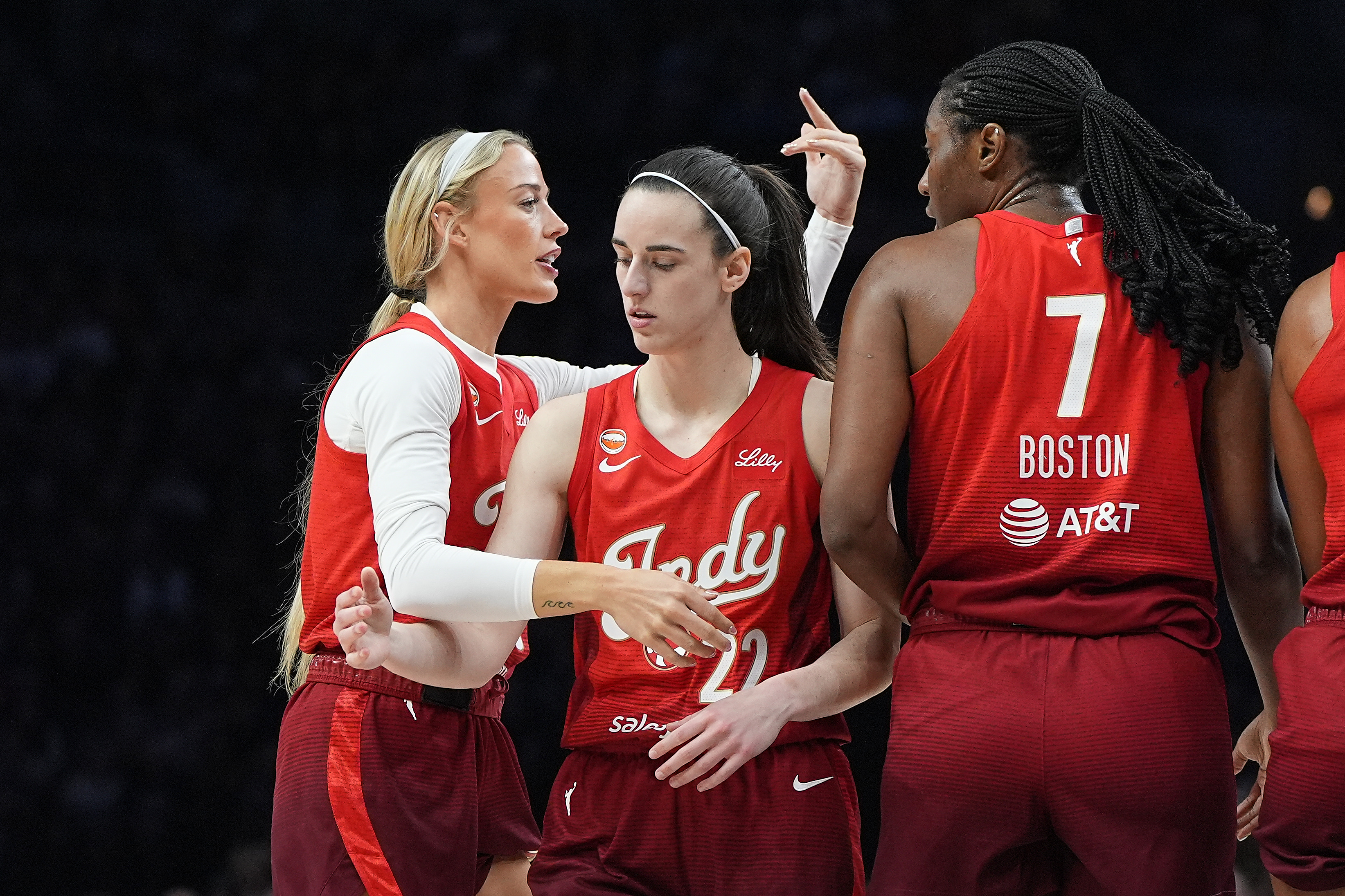 Indiana Fever guards Sophie Cunningham, left, Caitlin Clark (22) and center Aliyah Boston (7) stand on the court during the first half of a WNBA basketball game against the Minnesota Lynx, Sunday, Aug. 2, 2026, in Minneapolis. 