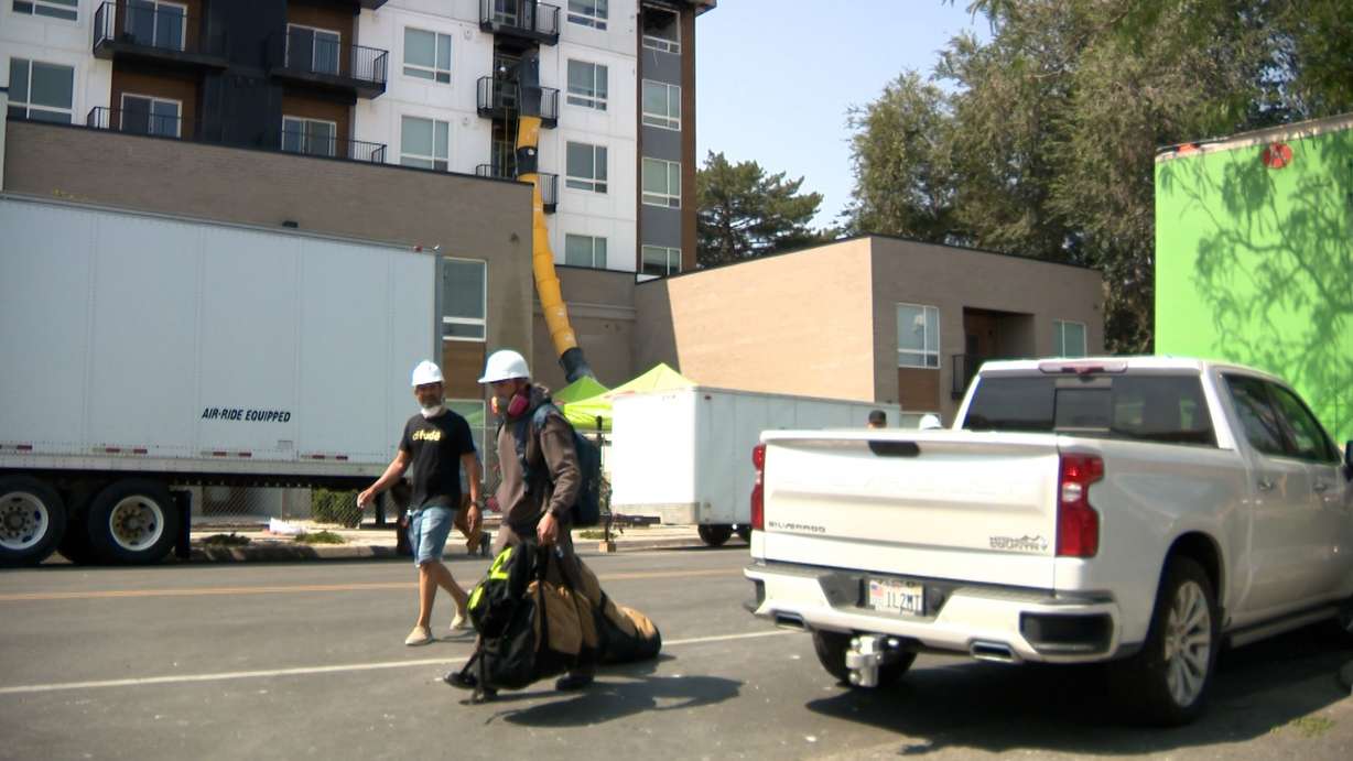 Kayky Mota, left, carries items out of North Union Apartments on Wednesday.