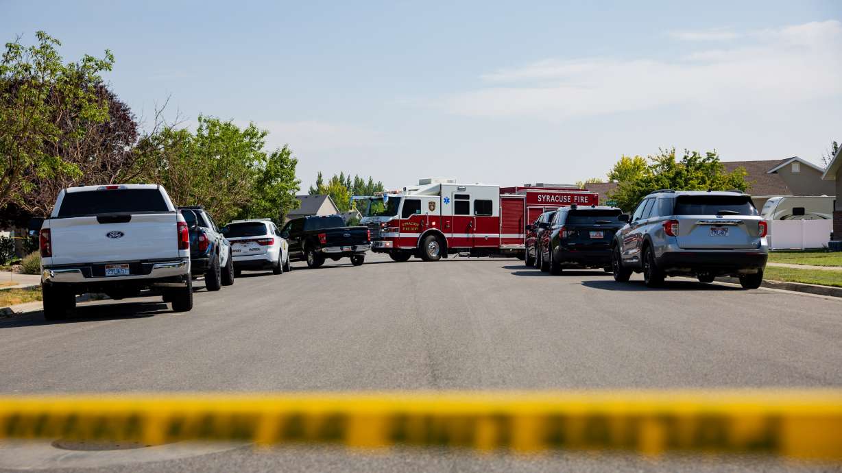 Police officers and the Syracuse Fire Department work the scene of a fatal collision where a pickup truck traveling south on Banbury Drive killed two 13-year-old juvenile females on an electric scooter traveling west on Heritage Parkway in Syracuse on Wednesday.
