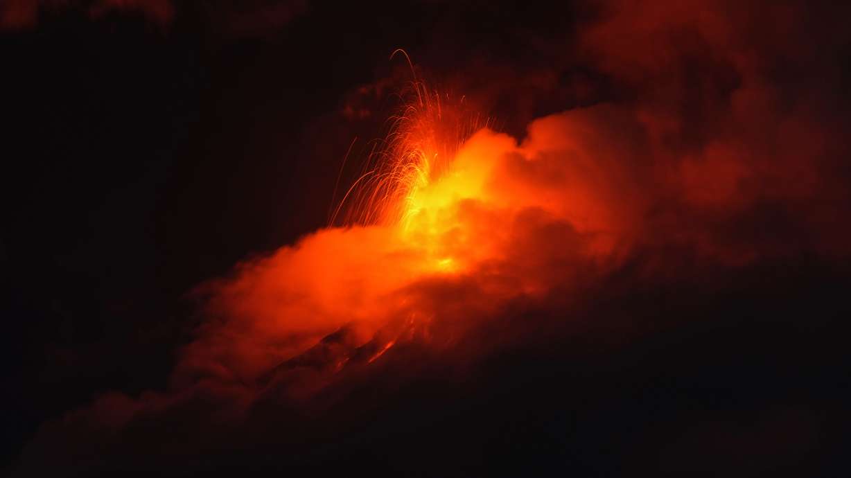Lava flows out of the crater of the Fuego Volcano, as seen from San Juan Alotenango, Guatemala, Tuesday. Activity at the volcano that began Monday morning and caused widespread evacuations is gradually decreasing, authorities said Wednesday.