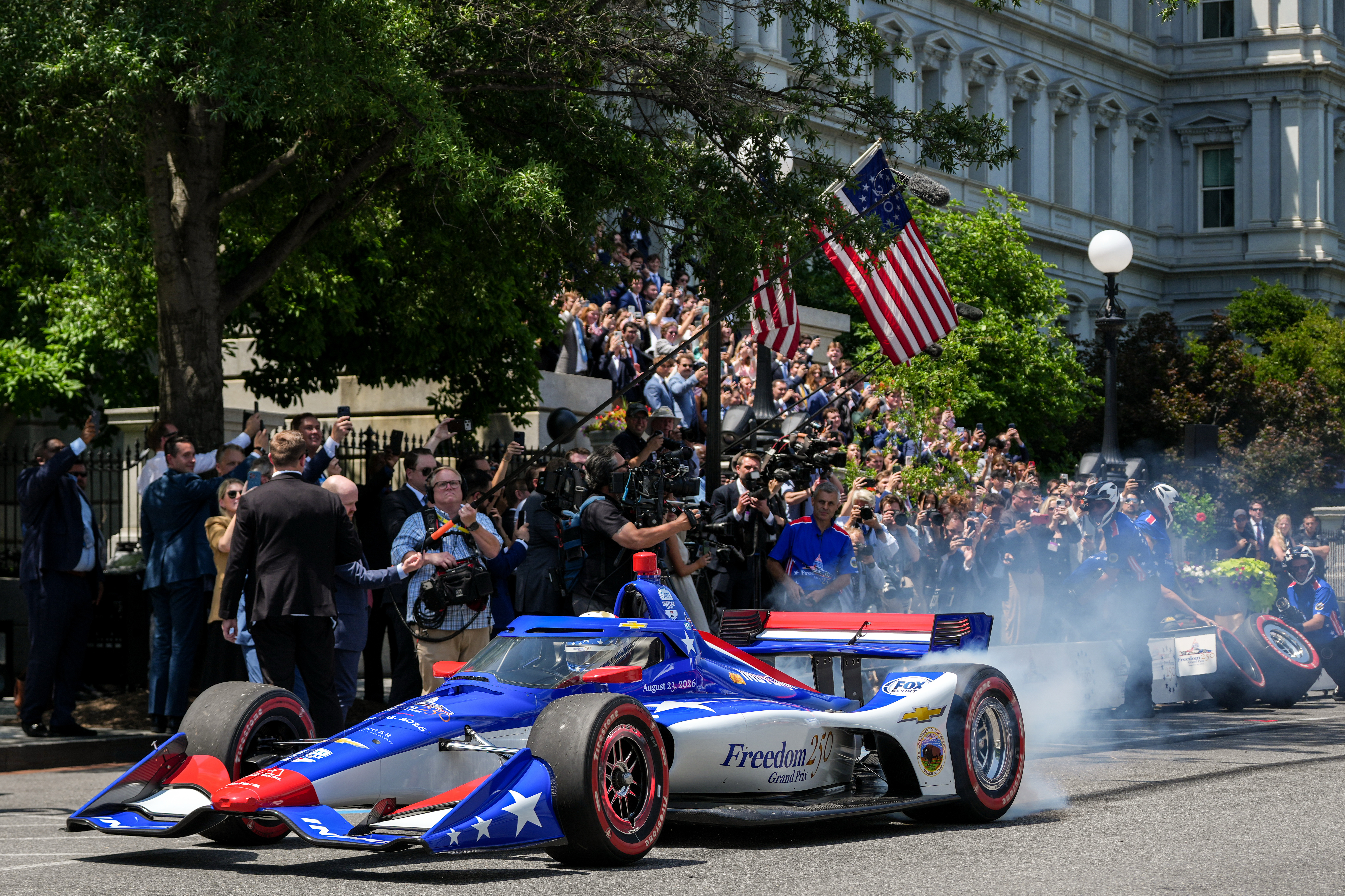 IndyCar Series driver David Malukas drives a race car down West Executive Drive during an event with President Donald Trump to promote the upcoming Freedom 250 Grand Prix auto race, Monday, July 13, 2026, at the White House in Washington. 
