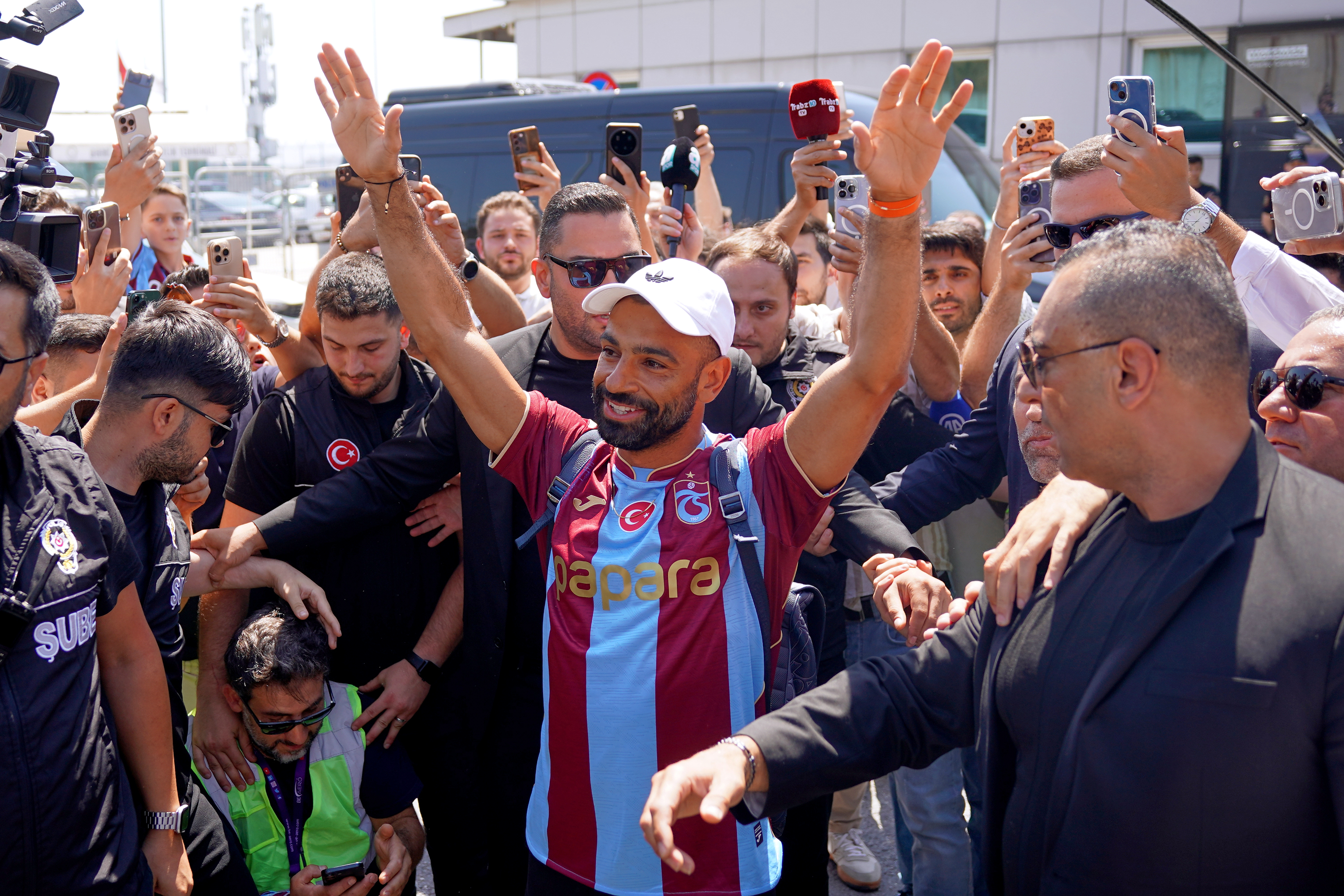 Egypt's Mohamed Salah wearing his new Trabzonspor team jersey gestures to supporters as he arrives at the airport in Istanbul, Turkey, Wednesday, Aug. 5, 2026. 