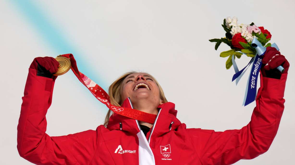 FILE - Lara Gut-Behrami, of Switzerland celebrates during the medal ceremony after winning the gold medal in the women's super-G at the 2022 Winter Olympics, Friday, Feb. 11, 2022, in the Yanqing district of Beijing.