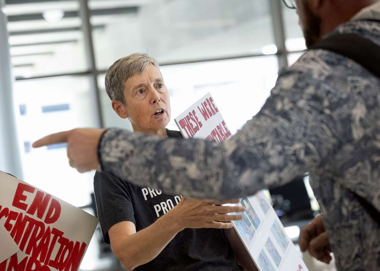 A handful of immigrant advocates gathered at Salt Lake City International Airport on Thursday to protest the regular immigrant detainee flights out of the facility. The photo shows Clare Coonan, one of the demonstrators.