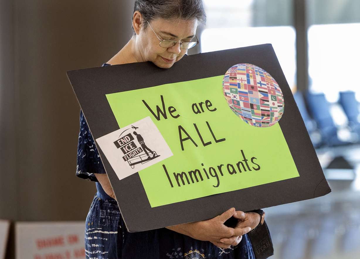A handful of immigrant advocates gathered at Salt Lake City International Airport on Thursday to protest the regular immigrant detainee flights out of the facility. The photo shows one of the demonstrators