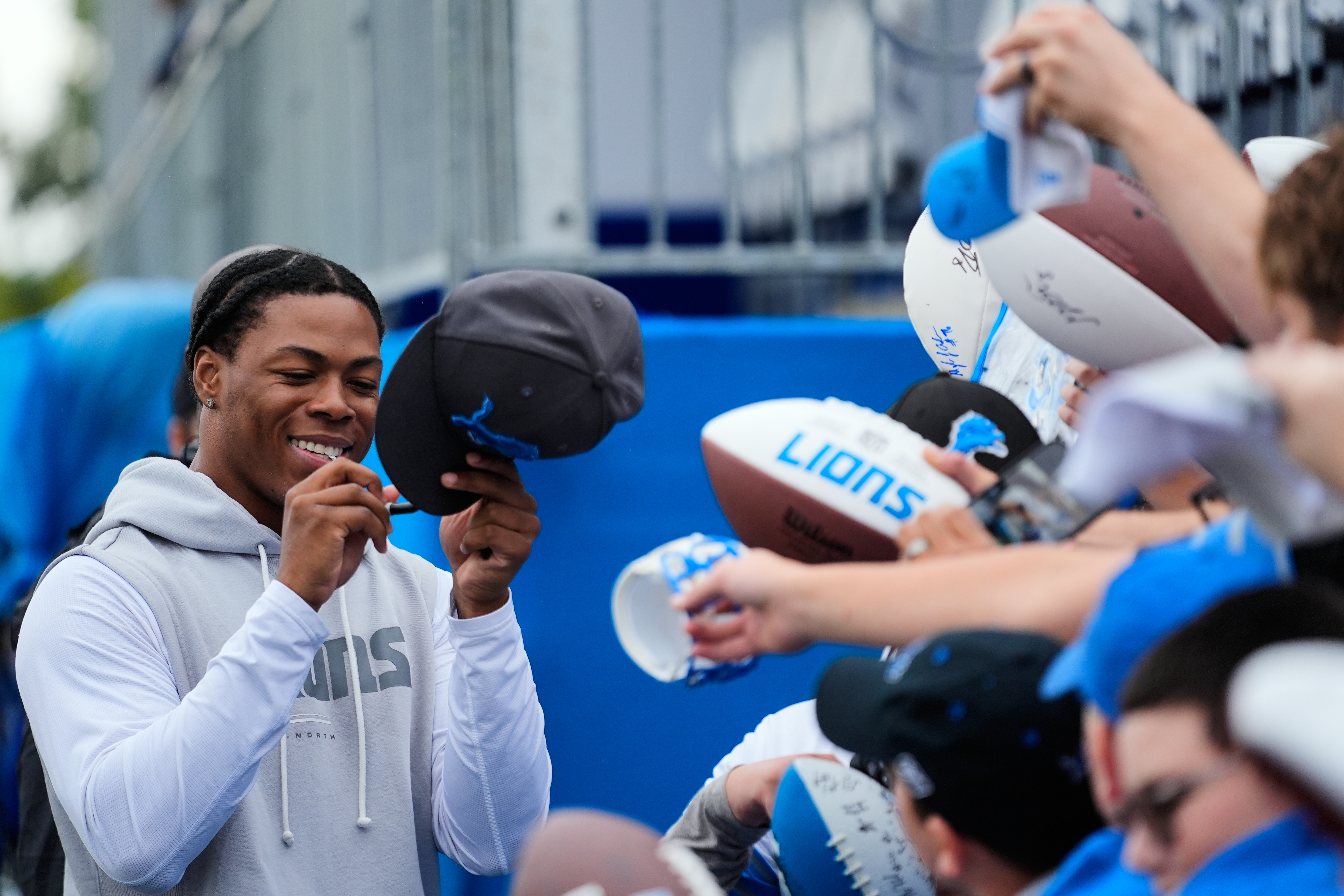 Detroit Lions running back Jahmyr Gibbs signs autographs for fans after practice at the NFL football team's training camp, in Allen Park, Mich., Sunday, Aug. 2, 2026. 