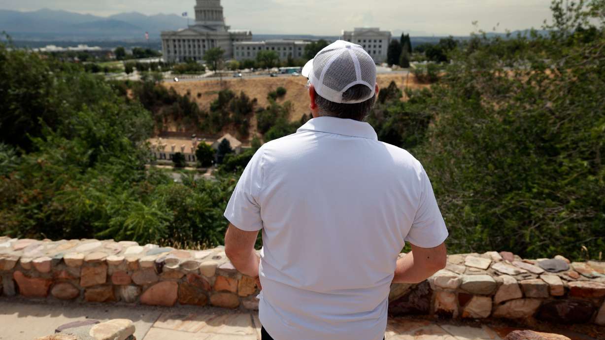 A Venezuelan refugee, who would like to be identified as Norberto, poses for a portrait overlooking the Capitol in Salt Lake City on July 22.