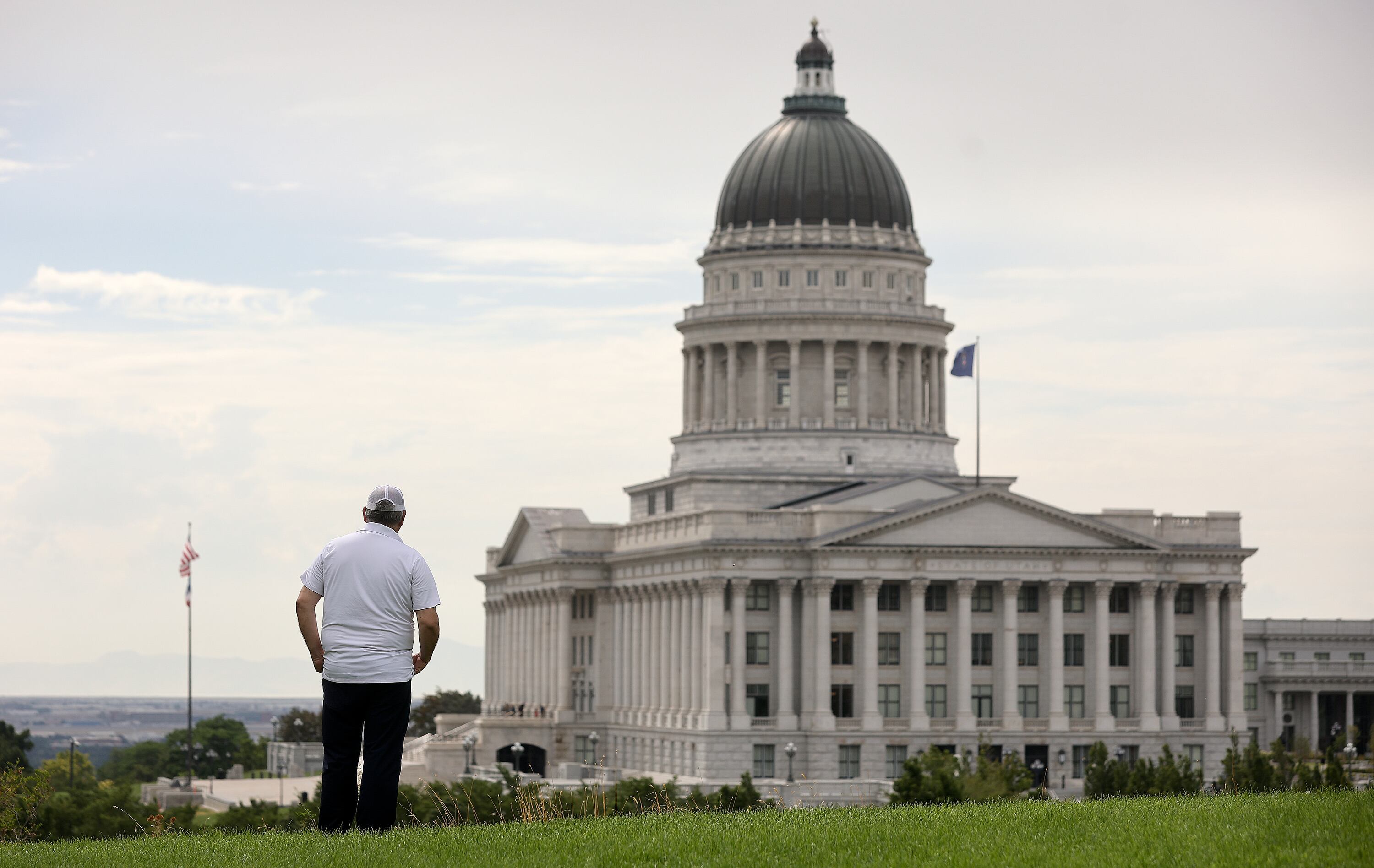 A Venezuelan refugee, who would like to be identified as Norberto, poses for a portrait overlooking the Capitol in Salt Lake City on July 22.