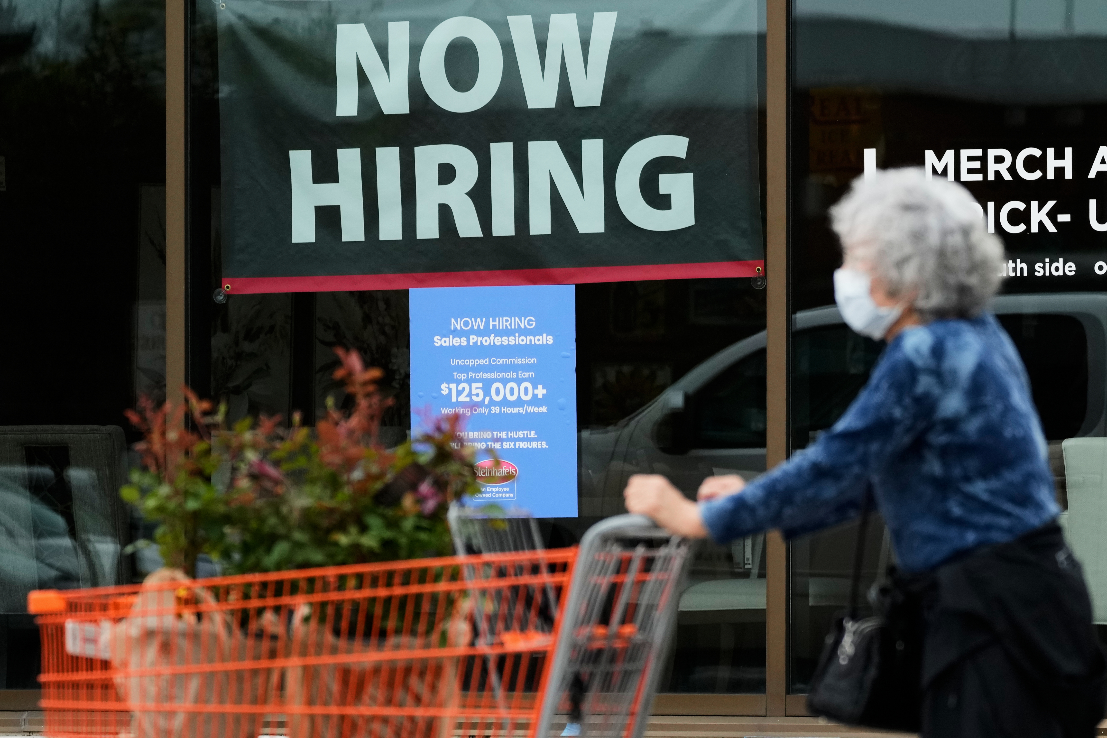 Hiring sign for sales professionals is displayed at a store, in Vernon Hills, Ill., April 15. A new jobs report on Friday showed unemployment fell to 4.1%, though employers cut 23,000 jobs due to economic strain from the Iran war.