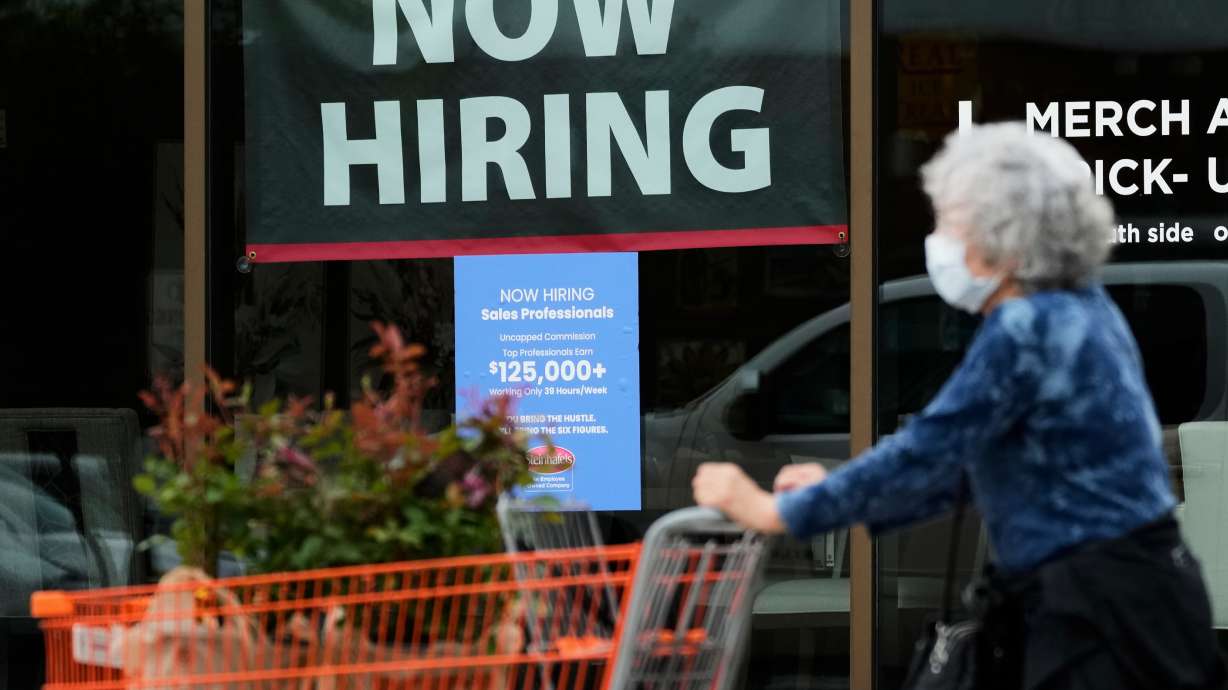 Hiring sign for sales professionals is displayed at a store, in Vernon Hills, Ill., April 15. A new jobs report on Friday showed unemployment fell to 4.1%, though employers cut 23,000 jobs due to economic strain from the Iran war.
