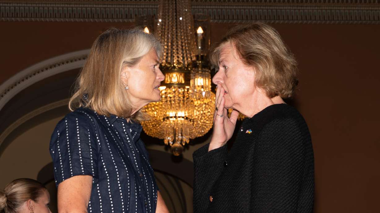 Sen. Lisa Murkowski, R-Alaska, talks with Sen. Tammy Baldwin, D-Wis., at the Capitol, July 28, in Washington. Murkowski said in a statement she would oppose Todd Blanche's nomination as attorney general.