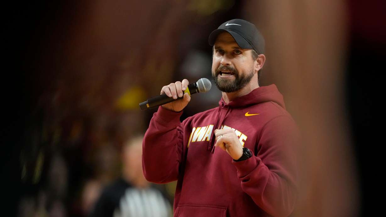 FILE - New Iowa State head football coach Jimmy Rogers speaks during a timeout in the first half of an NCAA college basketball game between Iowa State and Iowa, Dec. 11, 2025, in Ames, Iowa.