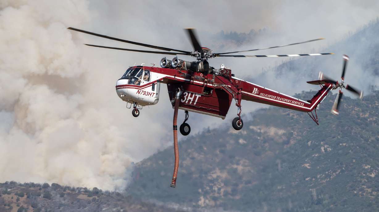 Photo: KSL News A Sikorsky S-64 Skycrane approaches to refill as crews fight the Widemouth 2 Fire east of Fillmore on Tuesday. Federal