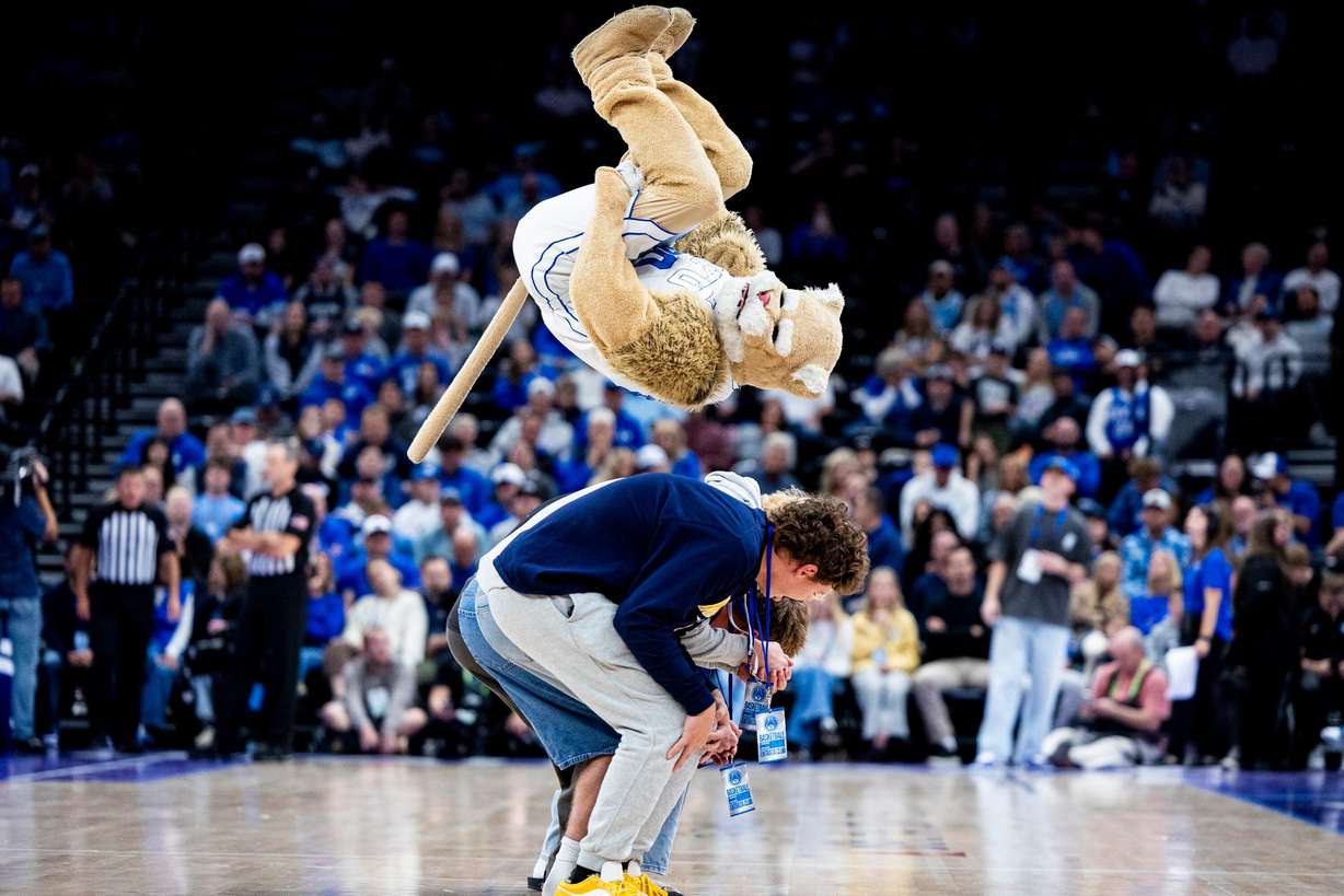 Cosmo the Cougar flips over fans during a men’s basketball exhibition game between BYU and North Carolina held at the Delta Center in Salt Lake City on Oct. 24. The beloved mascot will be inducted into the Mascot Hall of Fame.