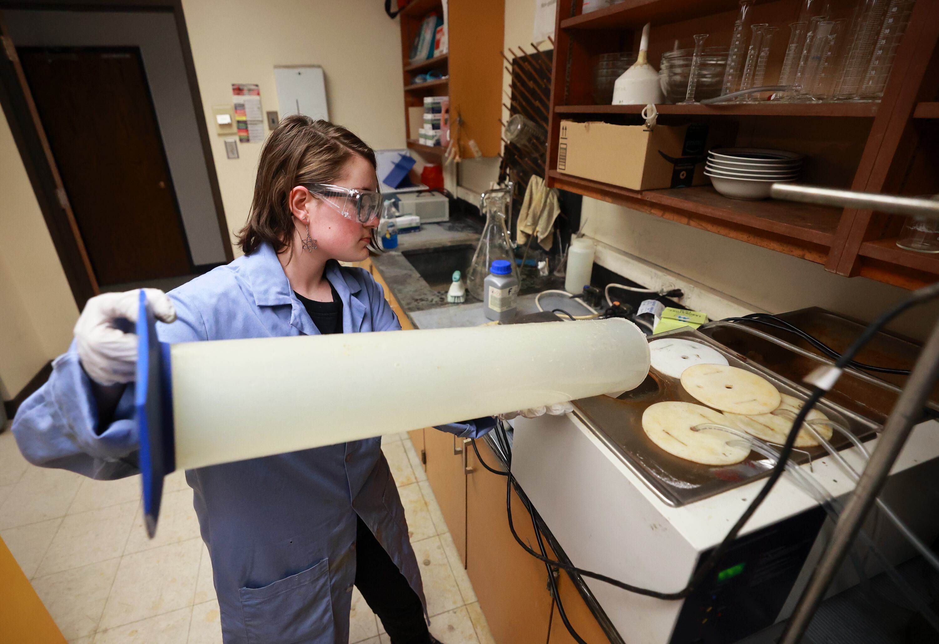 Kathryn Webster, University of Utah undergraduate researcher, refills a water bath to regulate the temperature of a bioreactor in the Bioreactor Lab at the University of Utah on July 23. Rep. Burgess Owens cosponsored the Mining School Act to provide grants to programs like these at other schools.