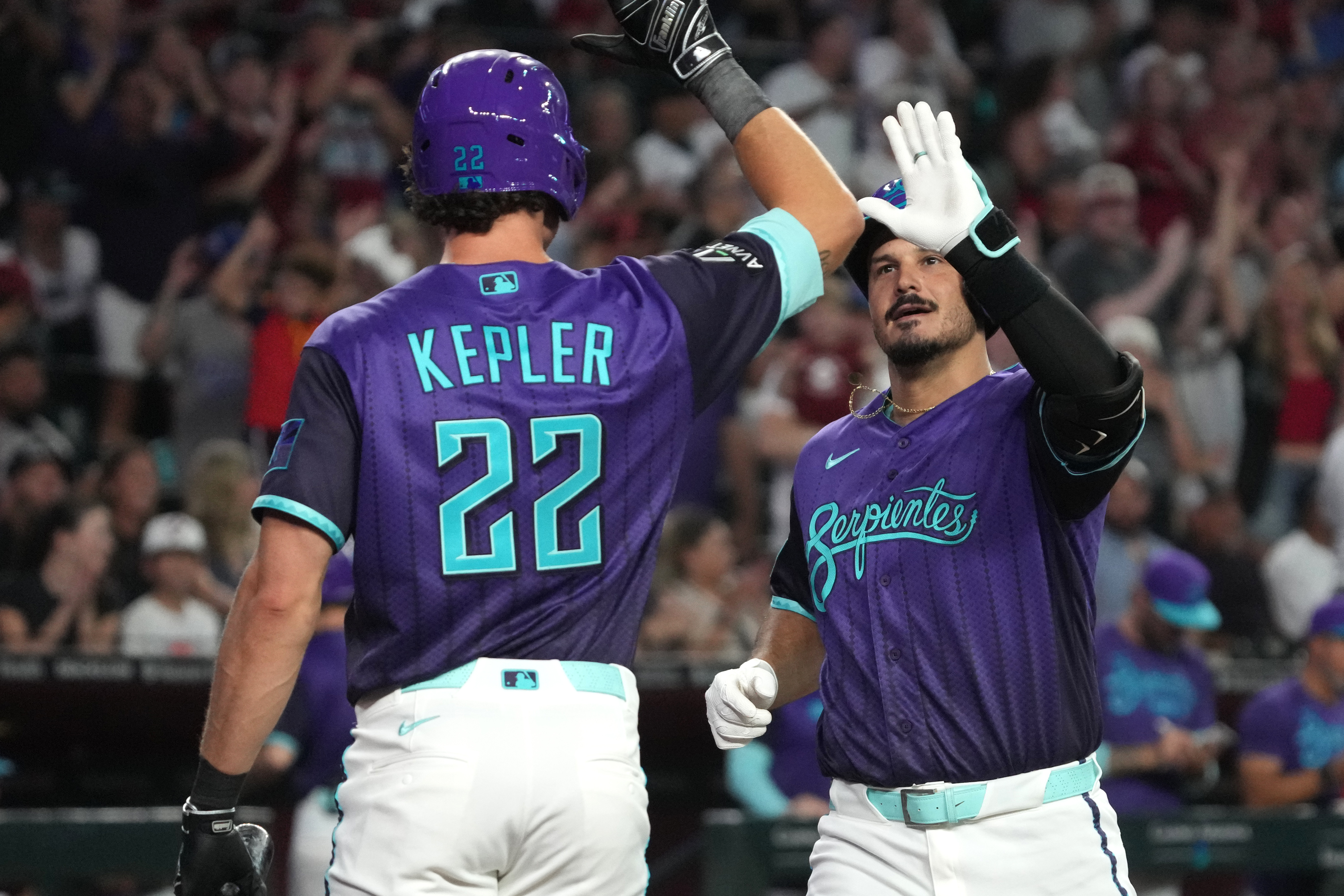 Arizona Diamondbacks' Nolan Arenado, right, celebrates with Max Kepler (22) after hitting a solo home run against the Los Angeles Dodgers in the second inning of a baseball game, Friday, Aug 7, 2026, in Phoenix. 
