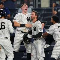 Yankees rally with 2 outs in 9th inning and beat Braves 3-2 in 10 after long rain delay