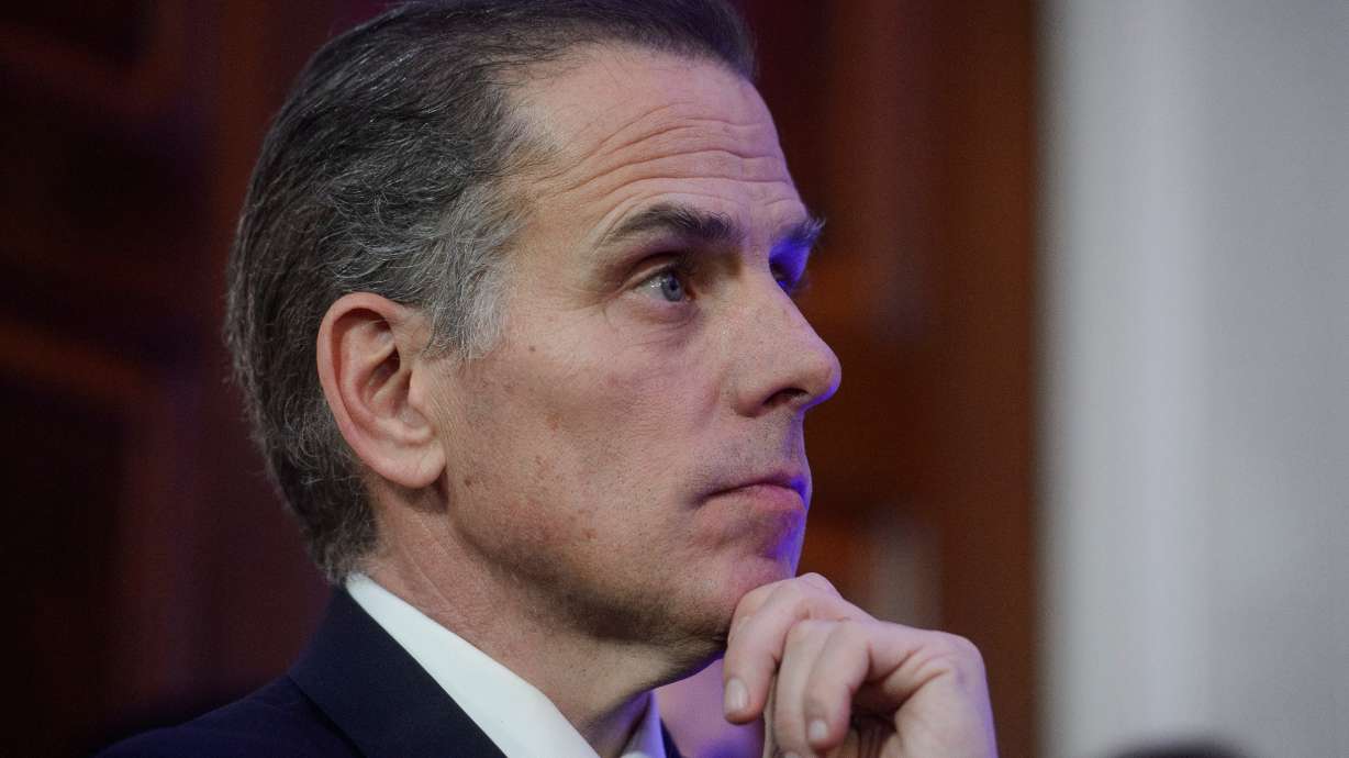 Hunter Biden listens while his father, then-President Joe Biden, speaks in the East Room of the White House in Washington, Dec. 16, 2024. Hunter Biden said in an interview the former president's cancer has spread, causing him pain.