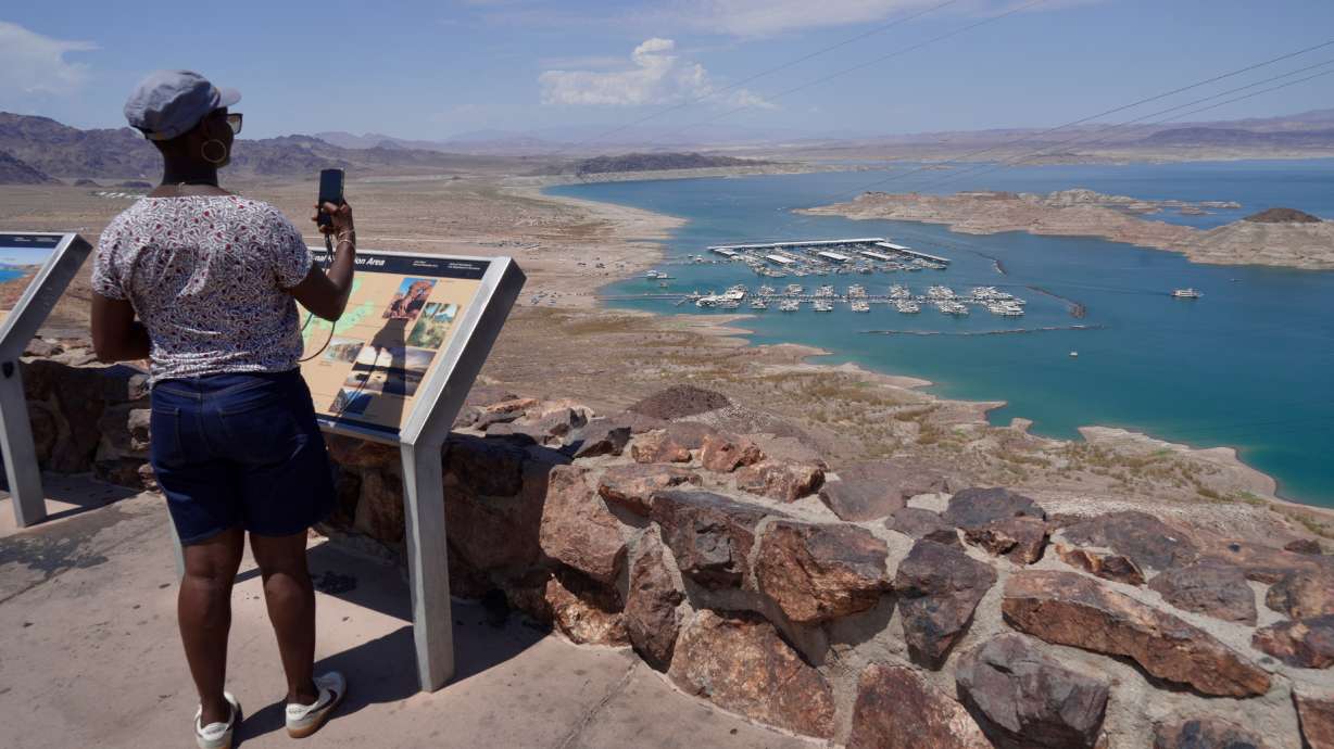 A tourist takes a photo of Lake Mead near Boulder City, Nev., on Friday. The United States' largest reservoir hit its lowest water level ever on Saturday.