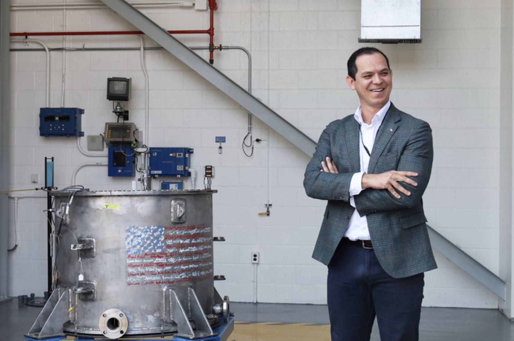 Deployable Energy CEO Bobby Gallagher stands next to the Unity Nuclear Battery.