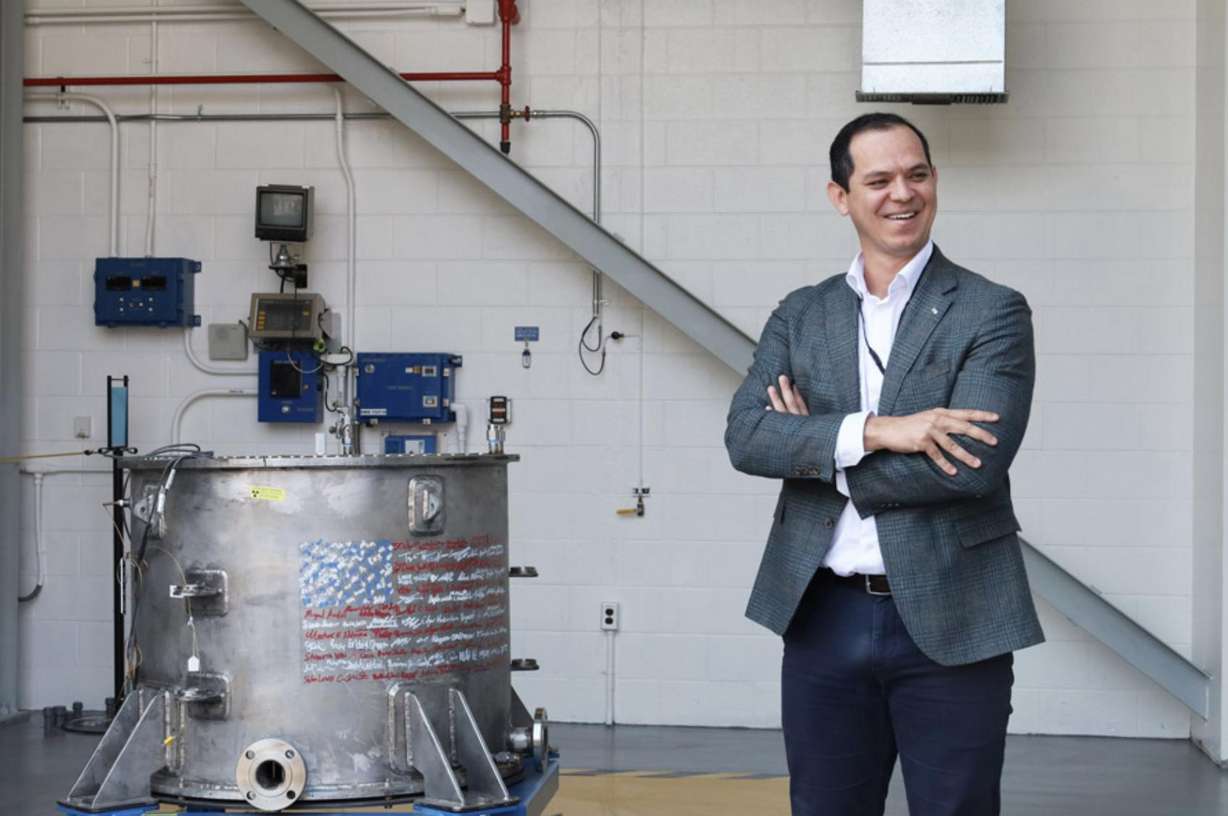 Deployable Energy CEO Bobby Gallagher stands next to the Unity Nuclear Battery.