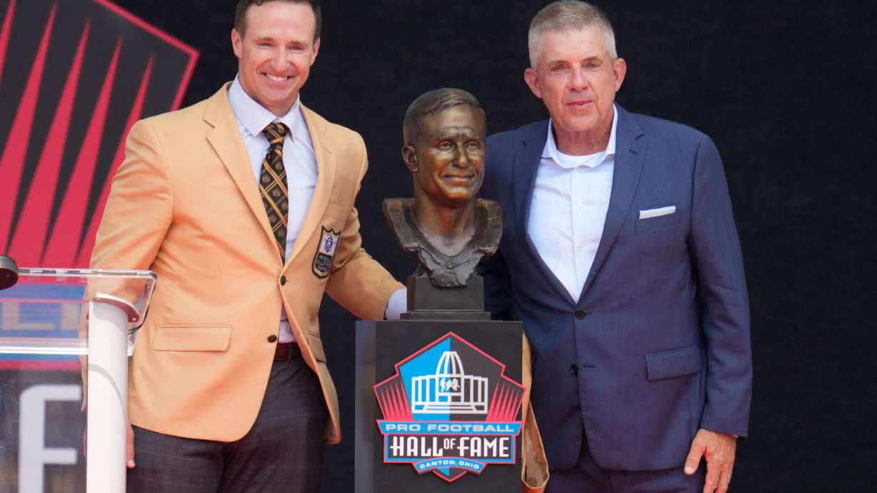 Former NFL player Drew Brees, left, unveils his bust with Sean Payton during the Pro Football Hall of Fame induction ceremony at the Pro Football Hall of Fame, in Canton, Ohio, Saturday, Aug. 8, 2026.