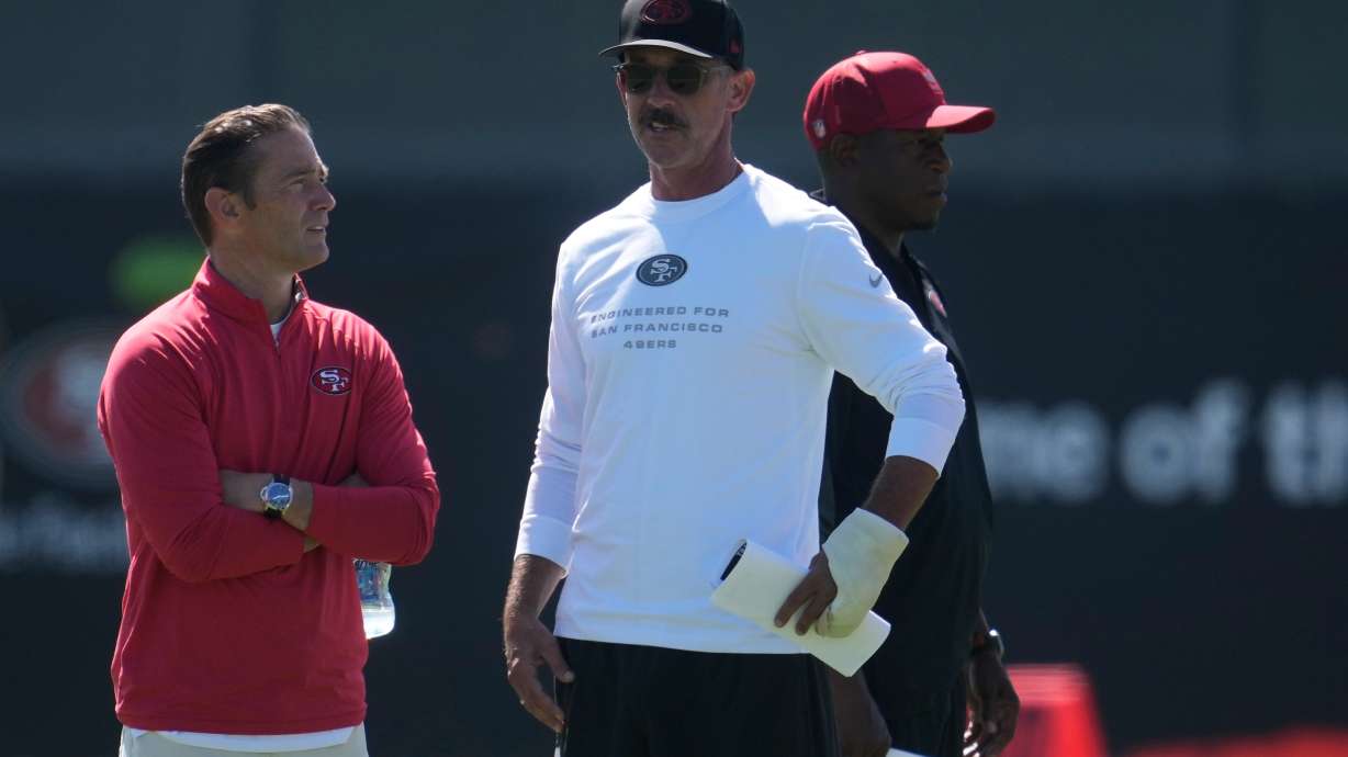 San Francisco 49ers head coach Kyle Shanahan, middle, watches players run drills during the NFL football team's training camp, Monday, Aug. 3, 2026, in Santa Clara, Calif.
