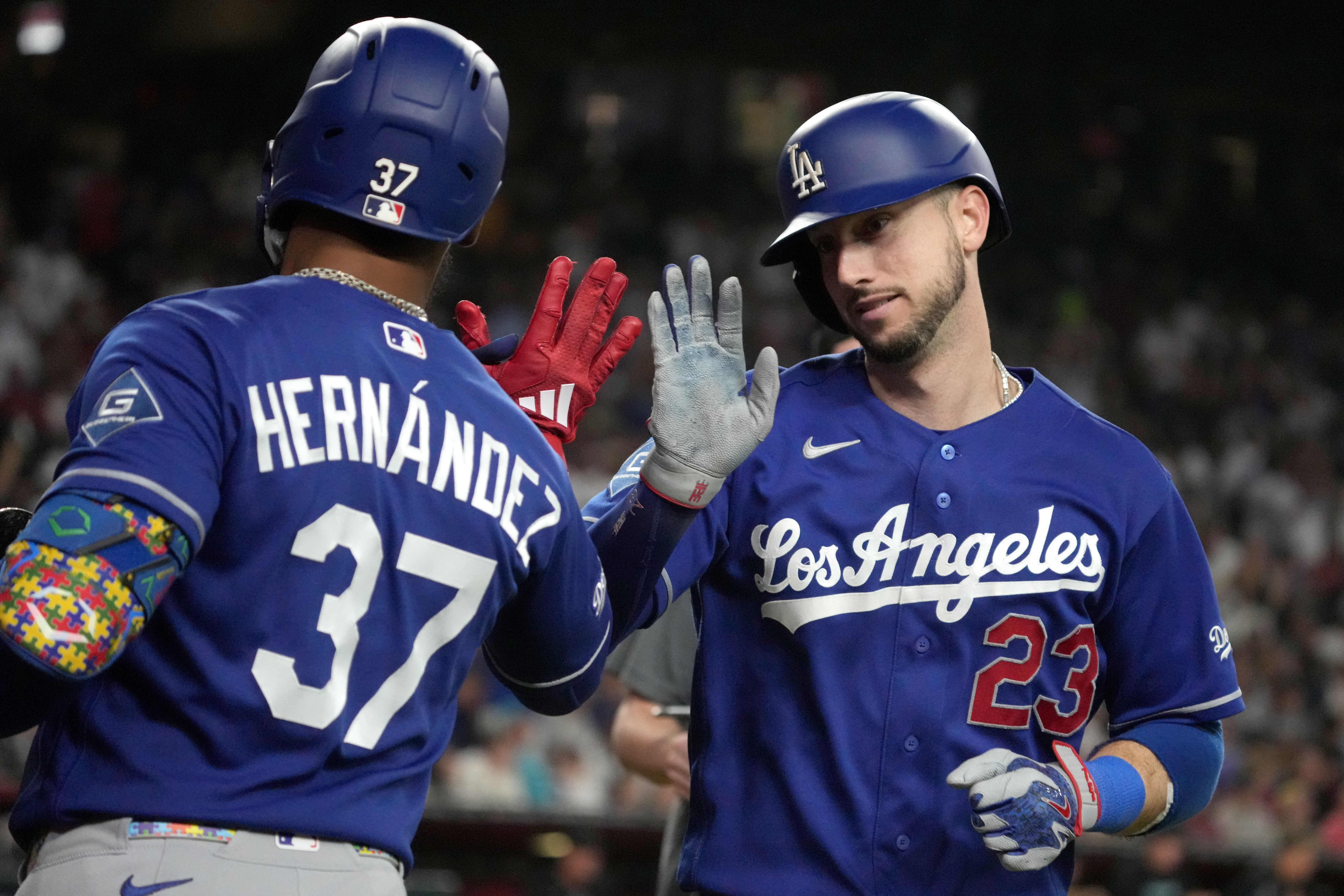 Los Angeles Dodgers' Kyle Tucker celebrates with Teoscar Hernández (37) after hitting a solo home run against the Arizona Diamondbacks in the eighth inning of a baseball game, Saturday, Aug. 8, 2026, in Phoenix. 