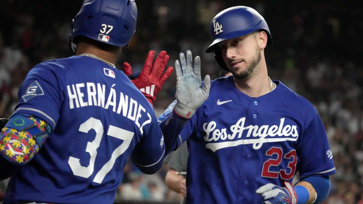 Los Angeles Dodgers' Kyle Tucker celebrates with Teoscar Hernández (37) after hitting a solo home run against the Arizona Diamondbacks in the eighth inning of a baseball game, Saturday, Aug. 8, 2026, in Phoenix.