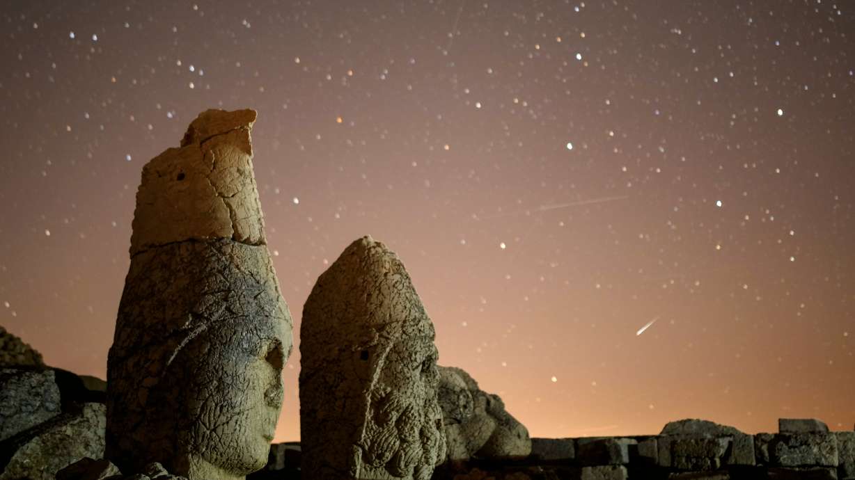 Ancient statues are seen during the Perseid meteor shower atop Mount Nemrut in southeastern Turkey, Aug. 11, 2024.