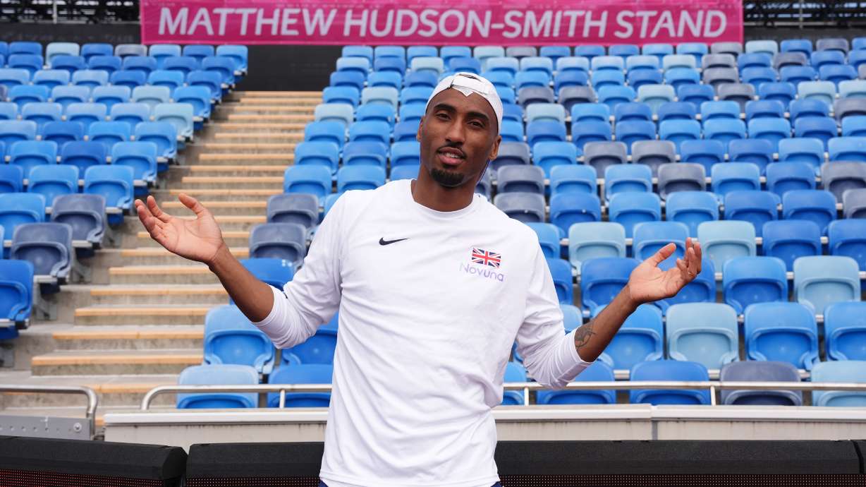 Britain's Matthew Hudson-Smith poses in front of a stand named after him, during a training session ahead of the start of the European Athletics Championships, in Birmingham, England, Sunday, Aug. 9, 2026.