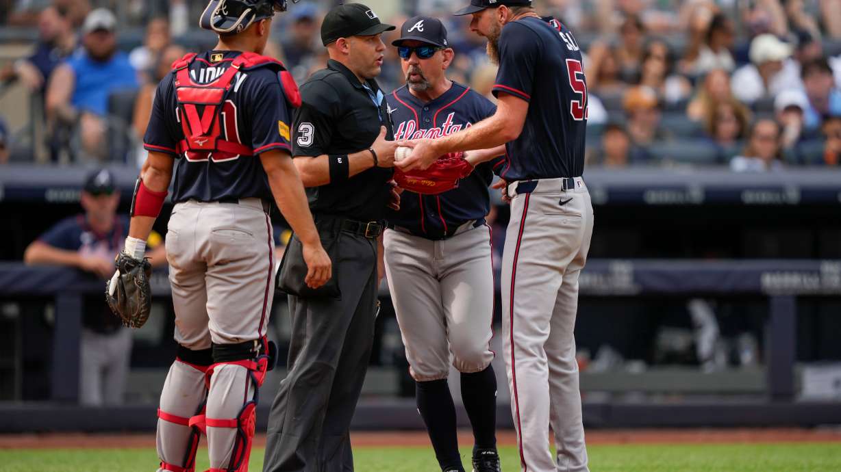 Atlanta Braves pitcher Chris Sale, right, argues with home plate umpire Dan Merzel, second left, during the fifth inning of a baseball game against the New York Yankees, Saturday, Aug. 8, 2026, in New York.
