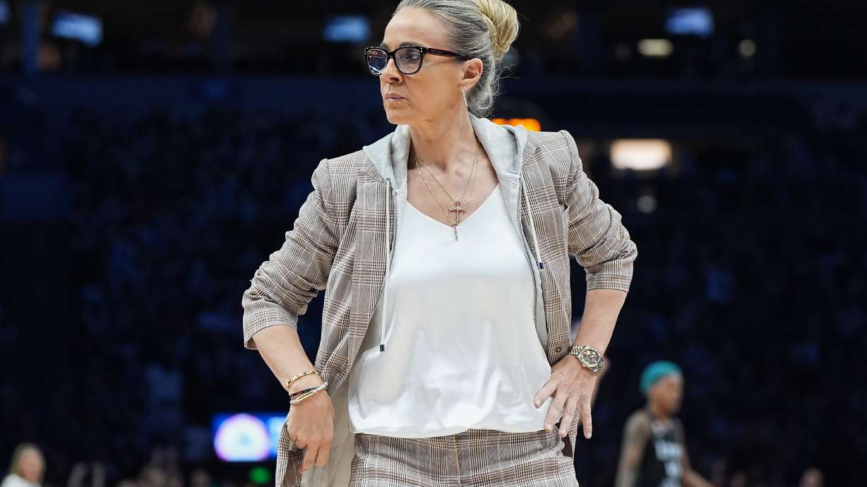 Las Vegas Aces head coach Becky Hammon stands on the court during a timeout in the first half of a WNBA basketball game against the Minnesota Lynx Saturday, Aug. 8, 2026, in Minneapolis.