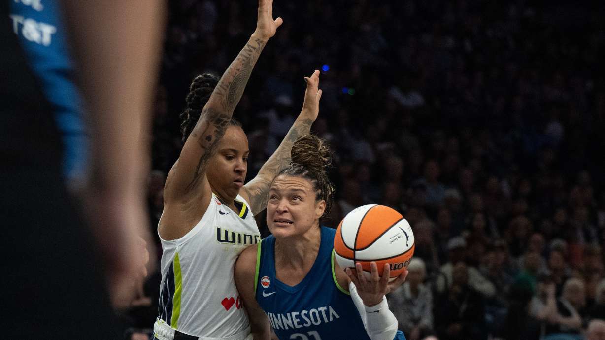 Minnesota Lynx guard Kayla McBride (21) dribbles to the basket on Dallas Wings guard Aziaha James in the fist half of basketball game, Sunday Aug. 9, 2026 in Minneapolis.